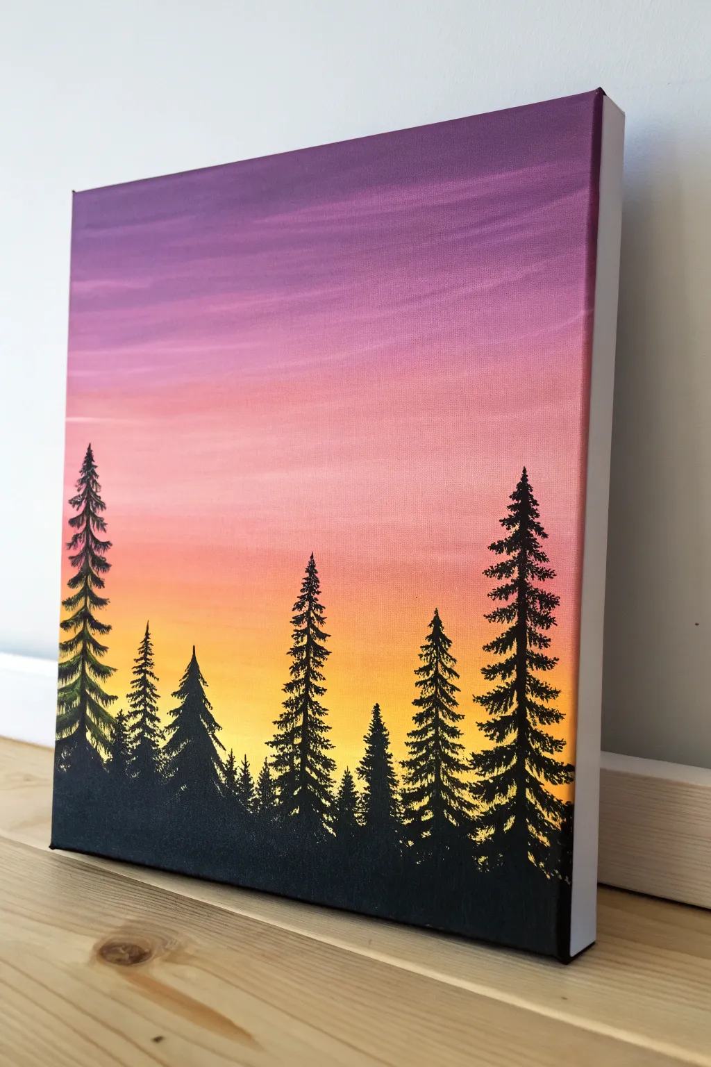 Sunset gradient acrylic canvas with bold black pine silhouettes for instant minimalist impact