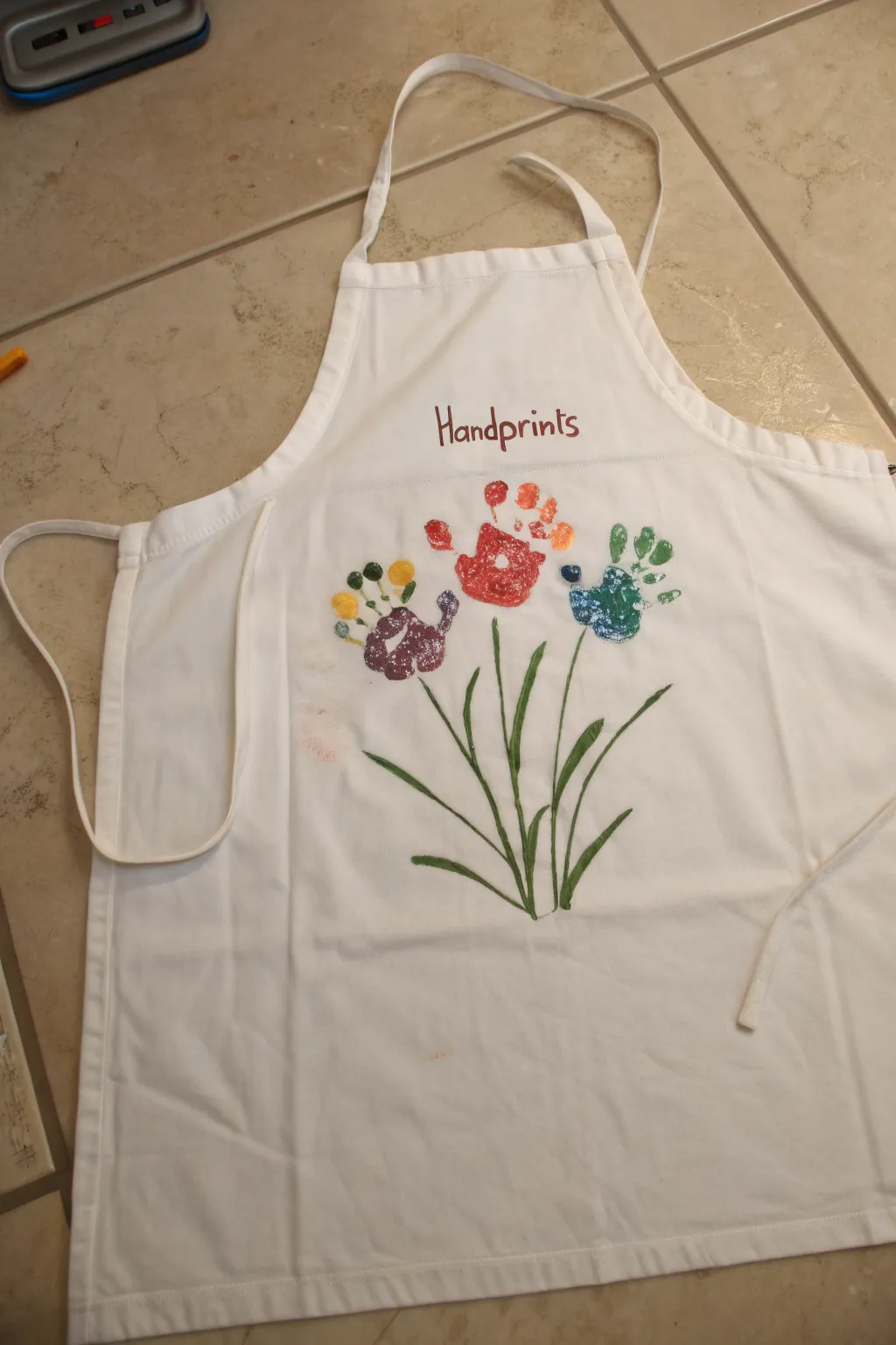 Turn little handprints into a bright bouquet apron keepsake, simple, sweet, and timeless.
