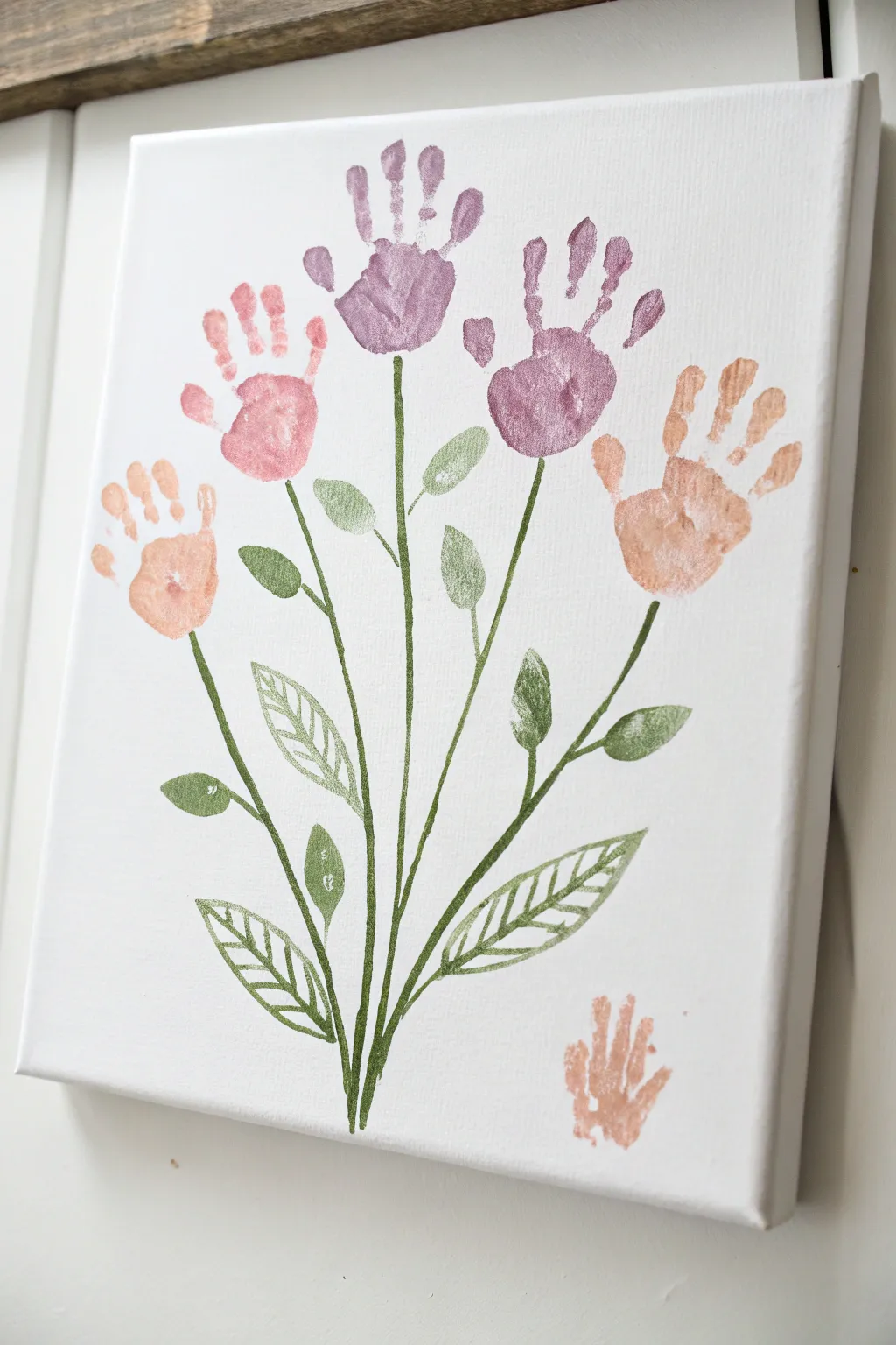 Minimal baby handprint bouquet canvas in soft pastels, crisp contrast, and cozy nursery vibes