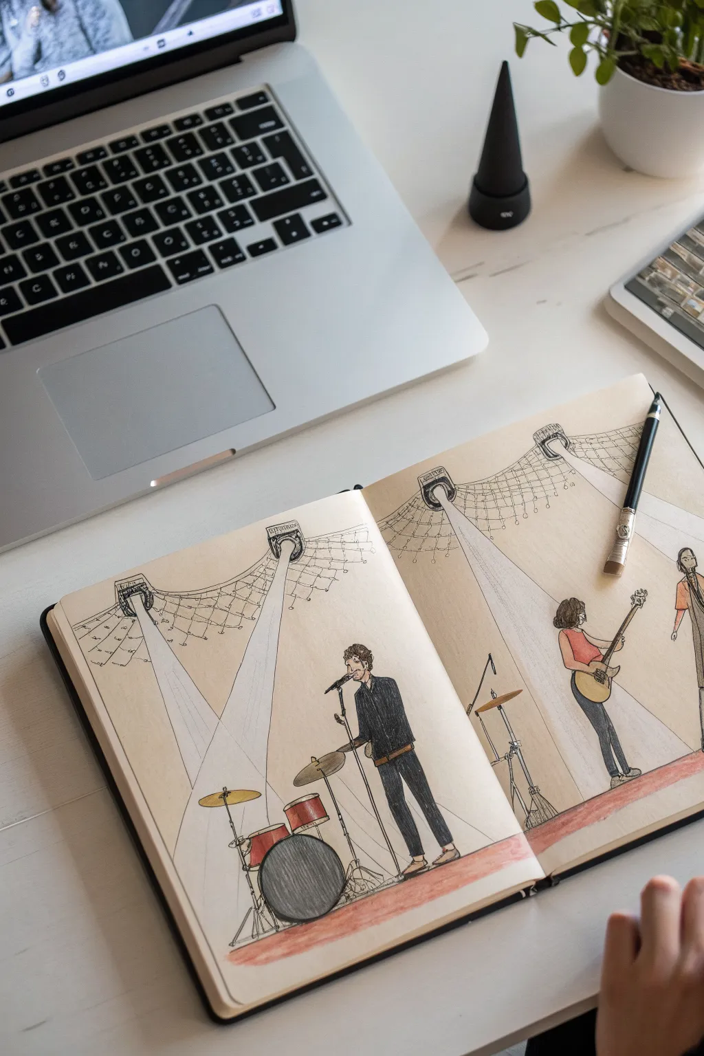 Concert stage sketch in a minimalist sketchbook, bold spotlights and silhouettes for band drawing ideas.
