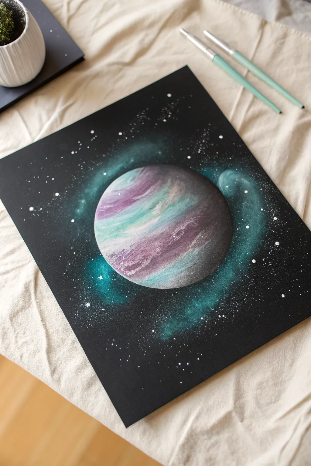 Beginner galaxy spray paint art: one bold planet mask with a dreamy nebula glow behind it
