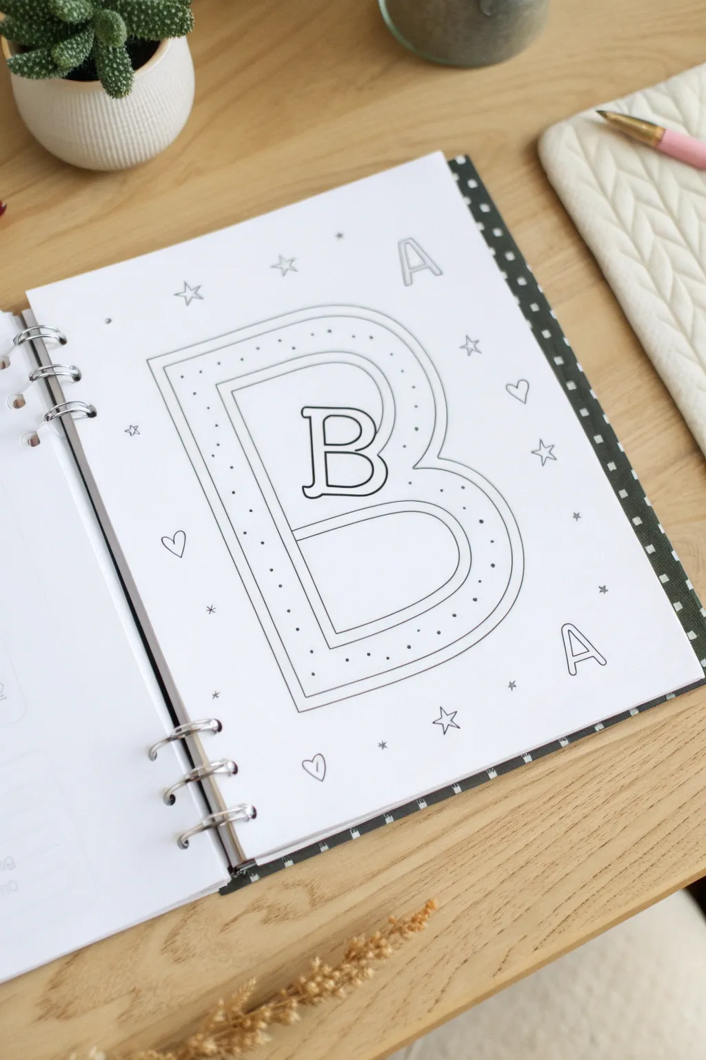Big bubble letter filled with mini doodles on a clean binder insert for minimalist study vibes.