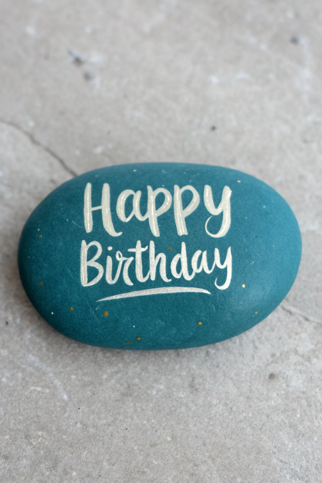 Classic birthday rock with bold hand lettering, minimalist boho vibe, crisp high-contrast close-up.