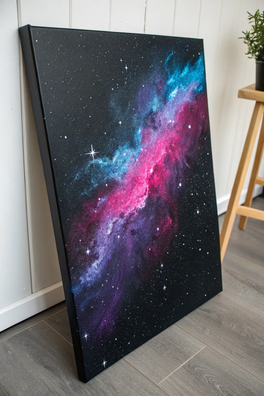 Neon galaxy glow on black canvas in UV light, with pink, blue, and purple cosmic clouds