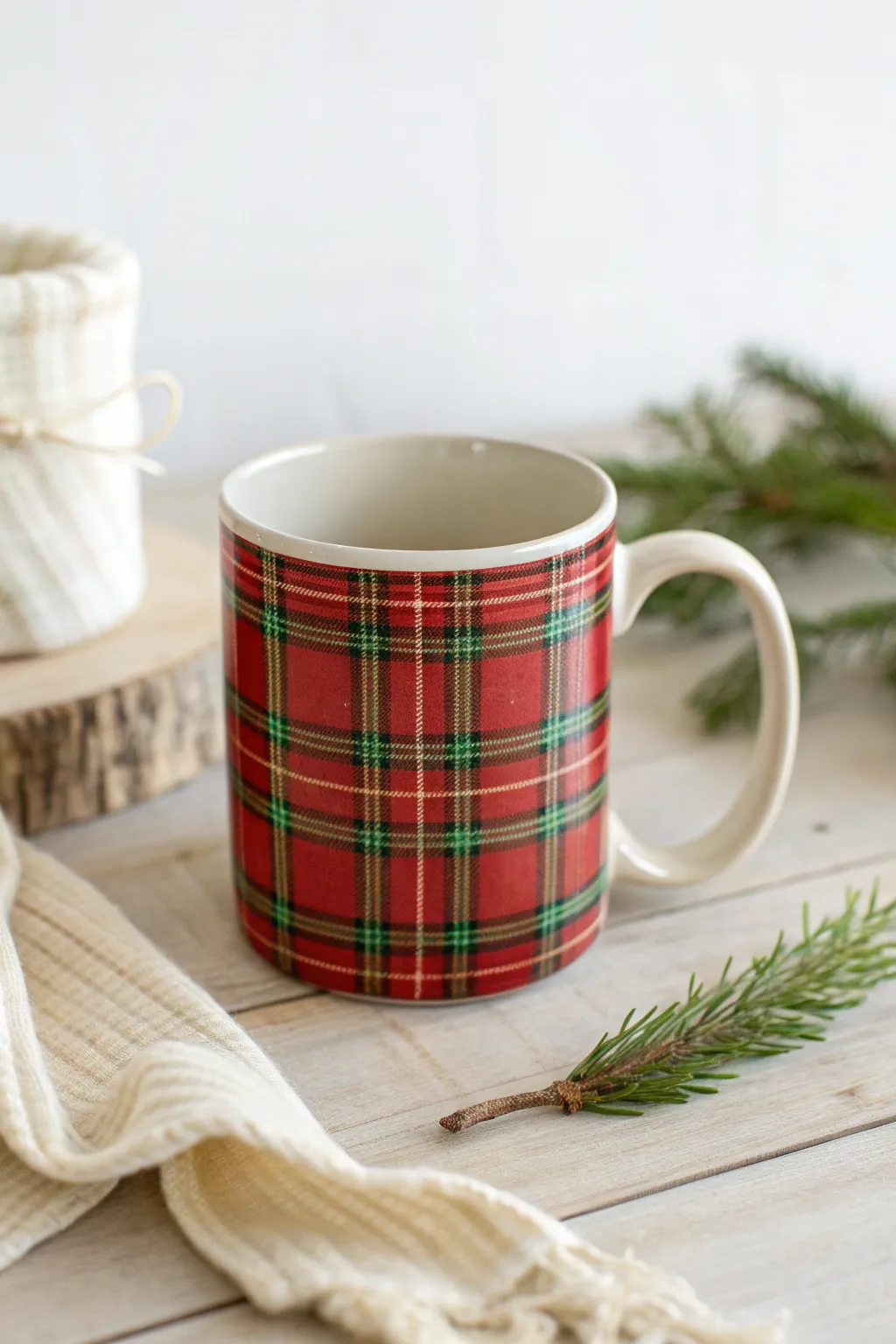 Classic red-and-green plaid mug styling with evergreen and ribbon for a timeless Christmas feel