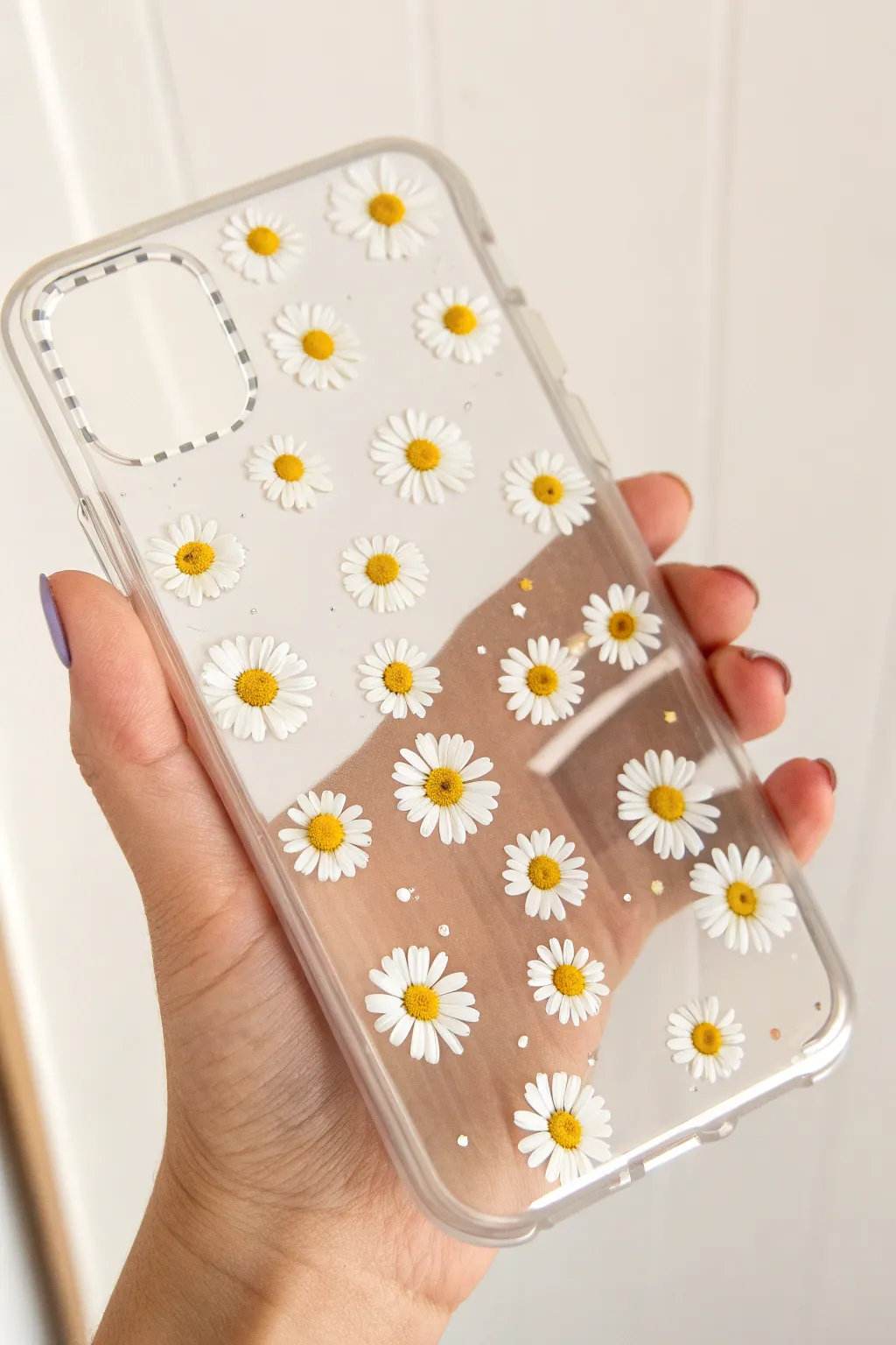 Tiny white daisies scattered on a clear case for an airy, sweet pattern with lots of see-through space