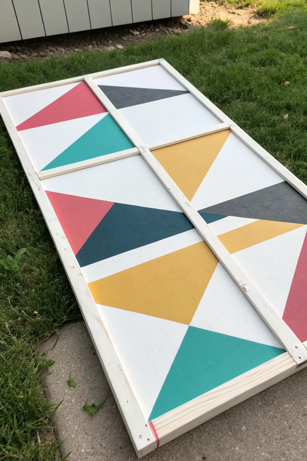 Tape-resist geometric canvas in three stages: blank, taped, and bold color reveal