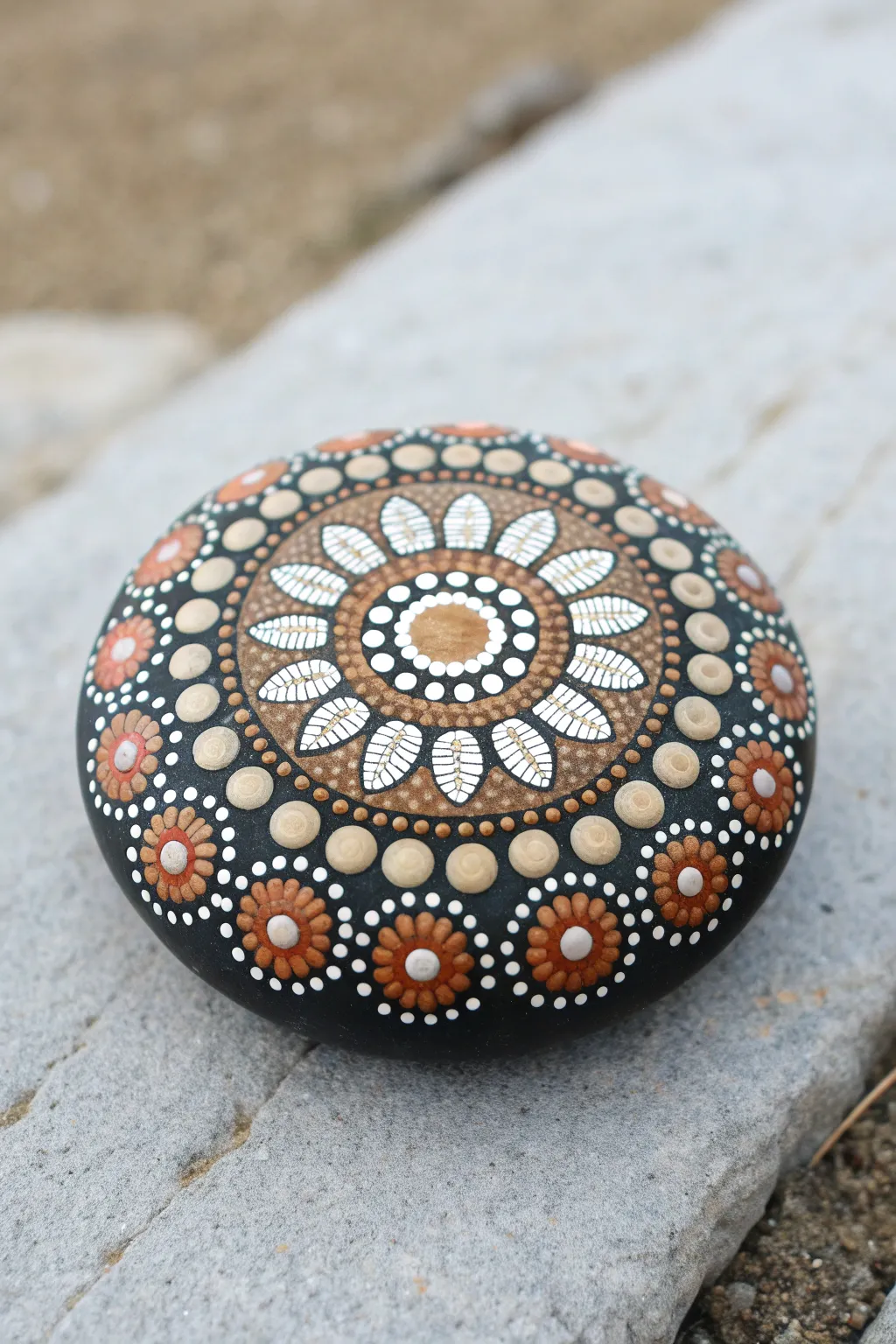 Classic dot mandala rock in soft light, minimalist boho styling, crisp symmetry and contrast.