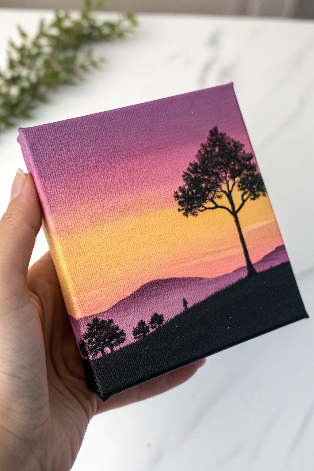 Soft sunset gradient with bold silhouette, a calming minimalist painting idea for beginners.