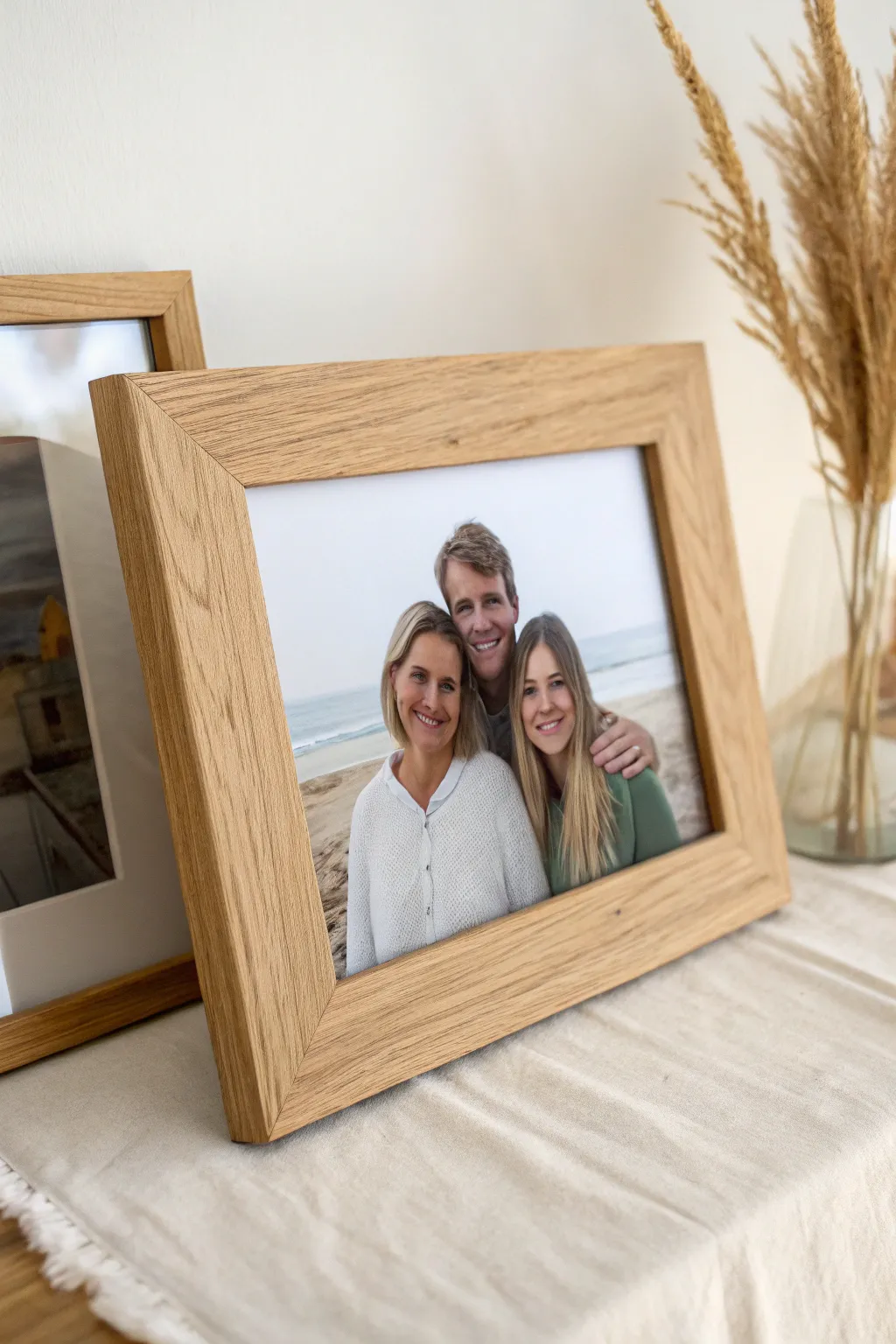 Timeless shoulder-to-shoulder family portrait in a minimalist frame with warm, cozy contrast