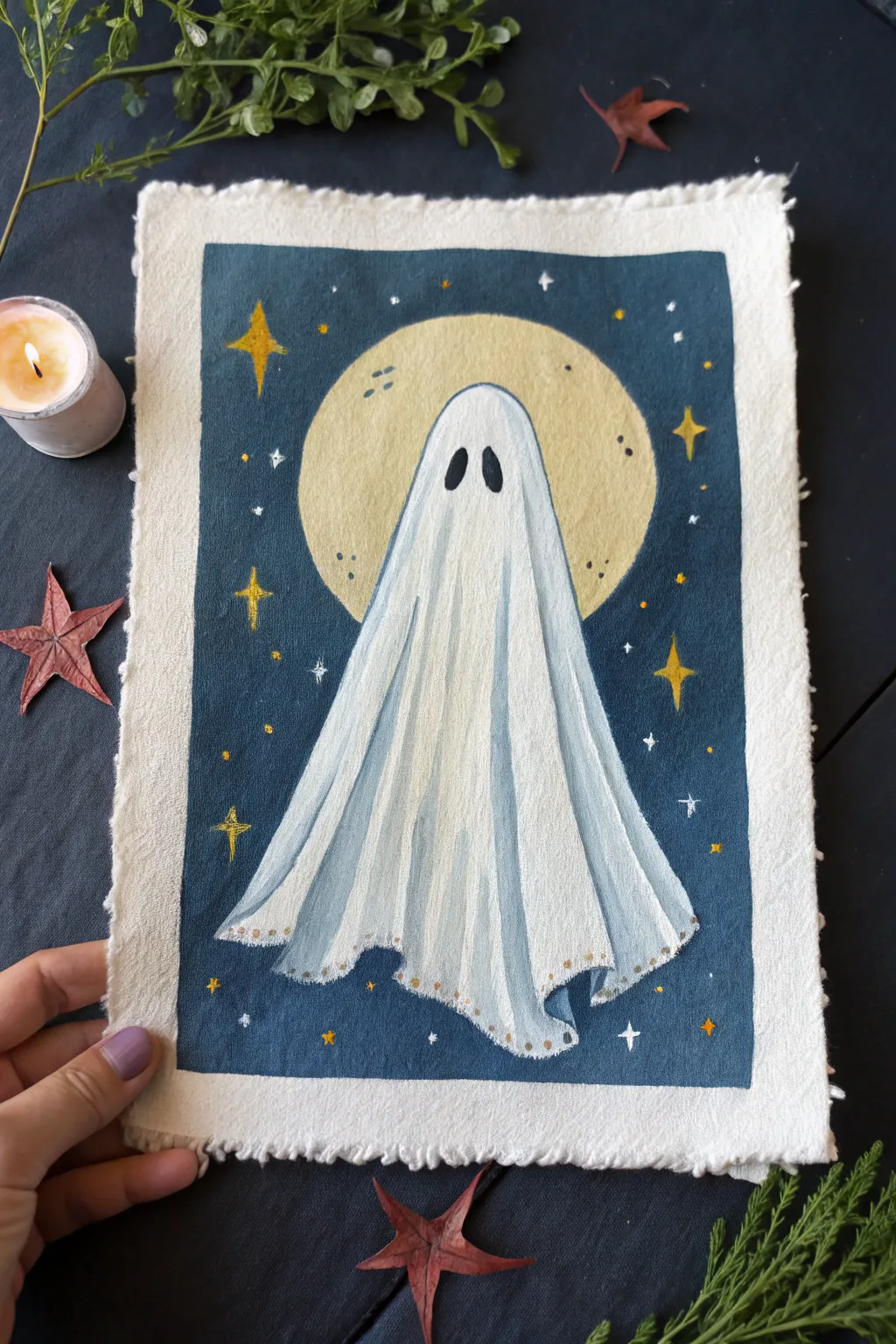 Classic sheet ghost painting under a glowing full moon, minimalist and cozy for spooky season