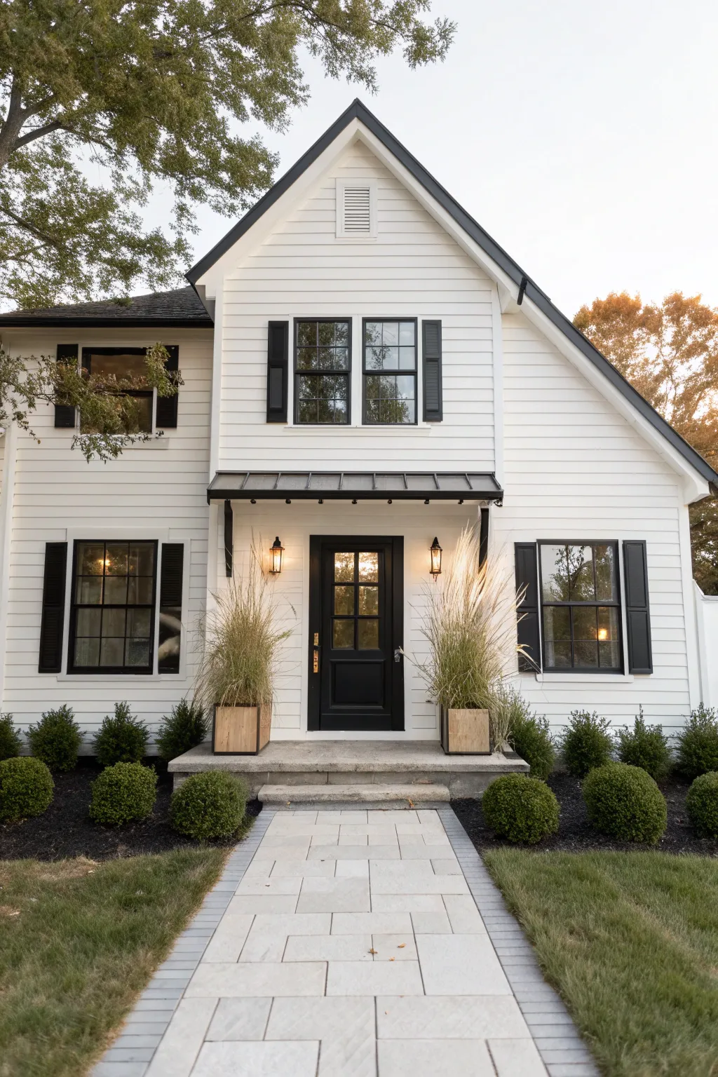 Classic curb appeal: bright white siding with crisp black trim in a calm, minimalist style
