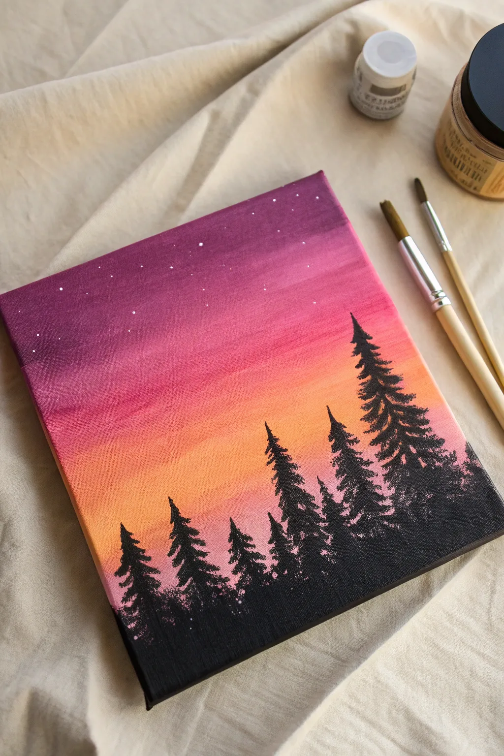 Sunset gradient canvas with bold pine silhouettes, a simple brush and tape for tutorial vibes