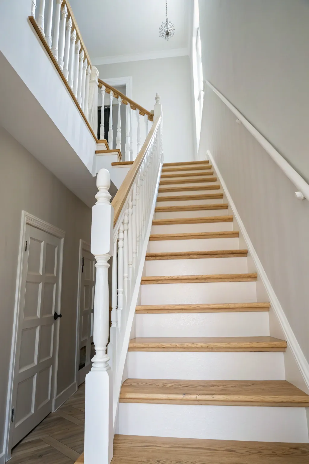 Crisp white staircase spindles brighten the whole entry, minimalist and timeless.