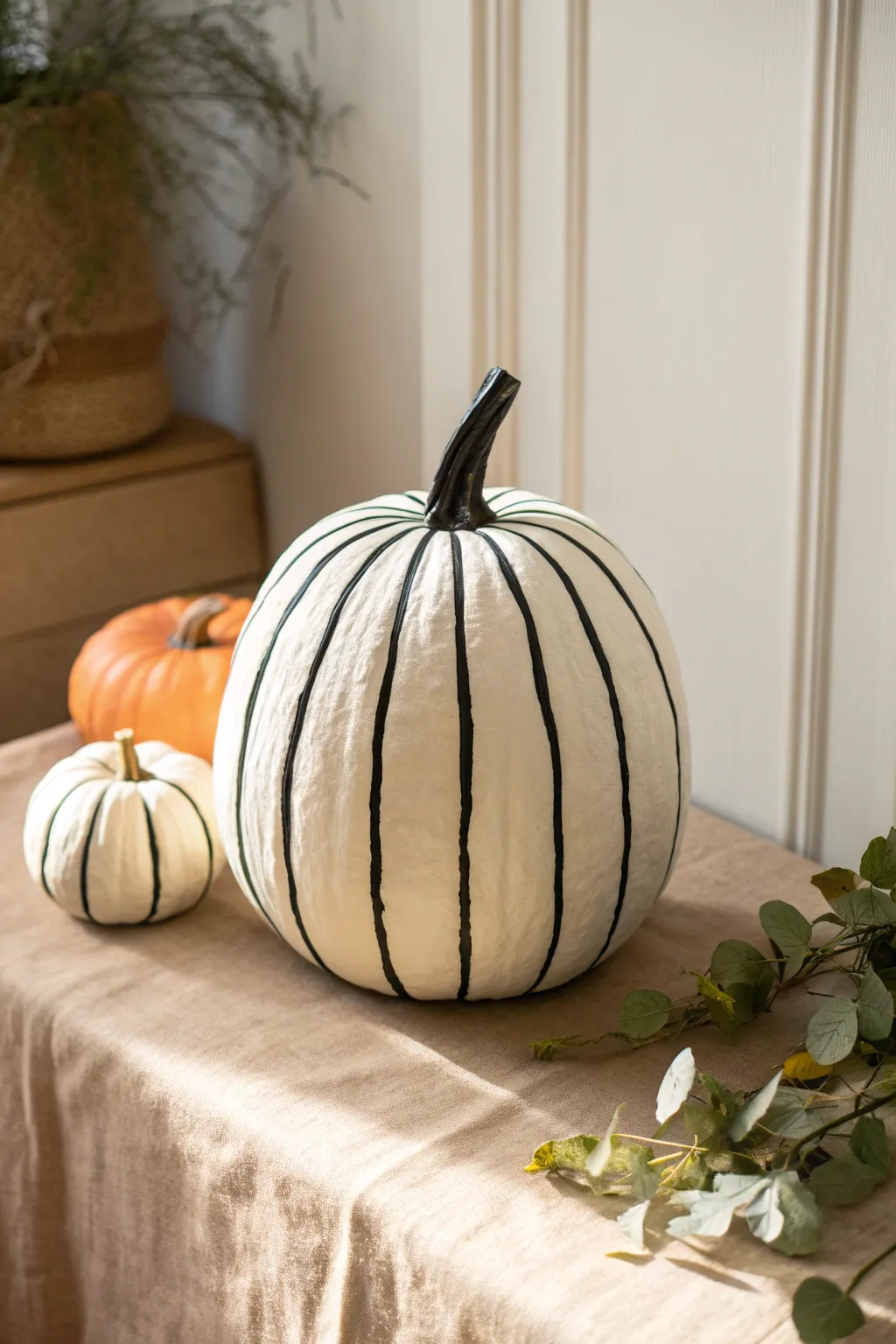 Classic black-and-white striped pumpkin for a clean, modern Scandinavian fall centerpiece