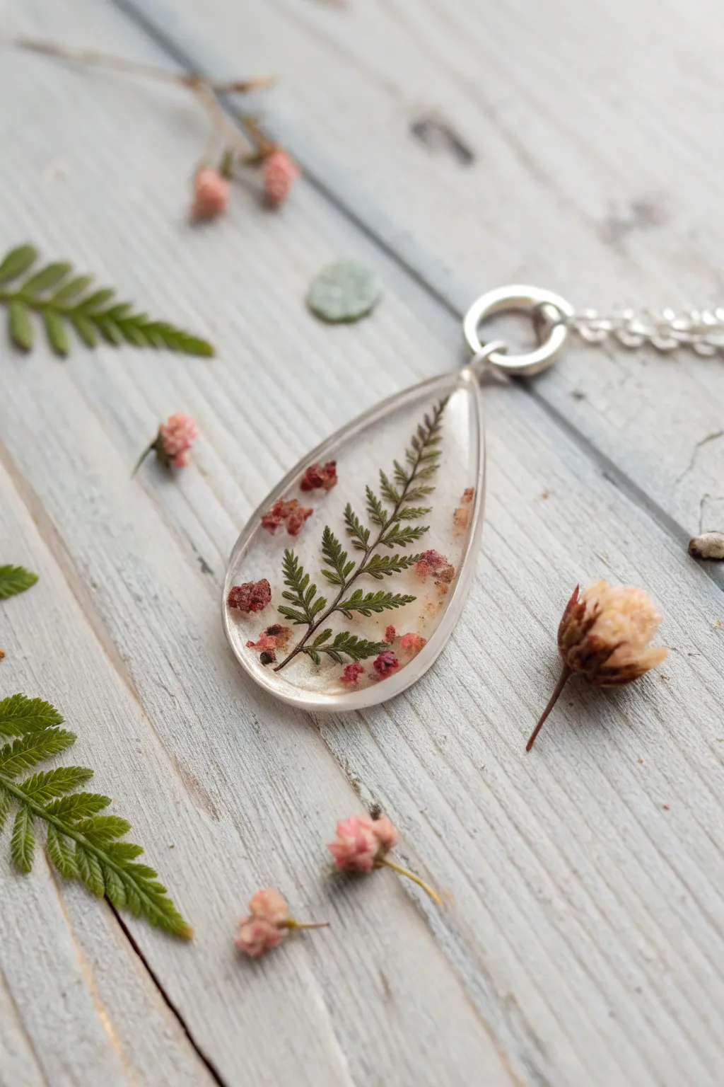 Delicate pressed petals suspended in clear resin, styled in calm Scandinavian minimalism.