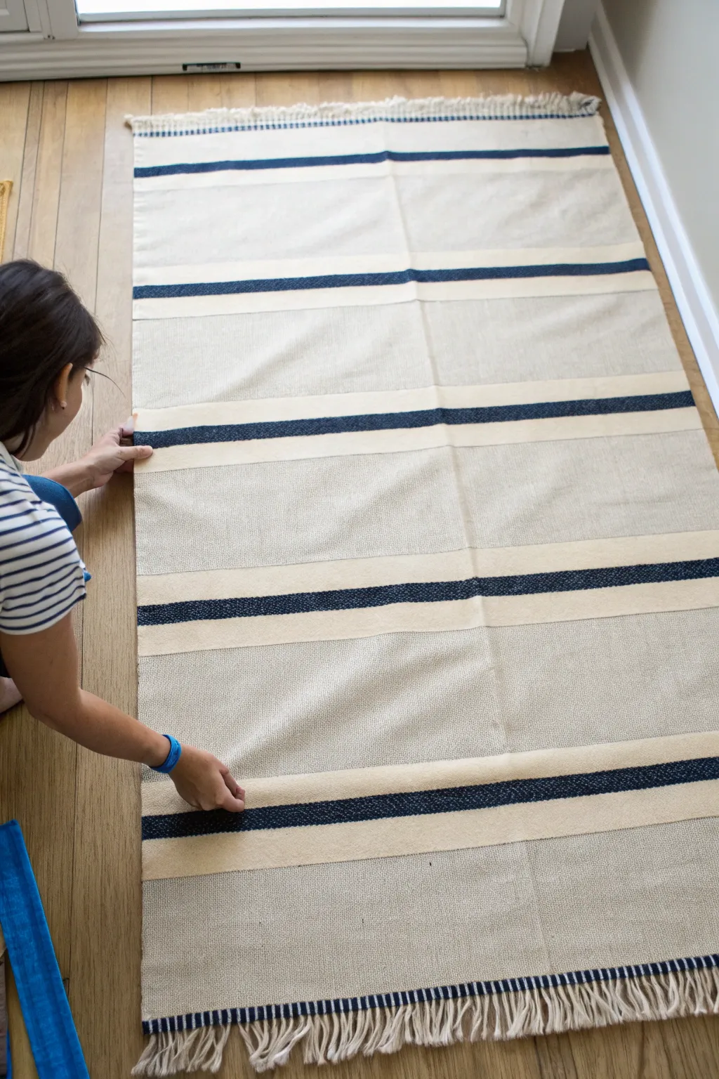 Crisp black and cream painted rug stripes with a satisfying painter’s tape peel reveal