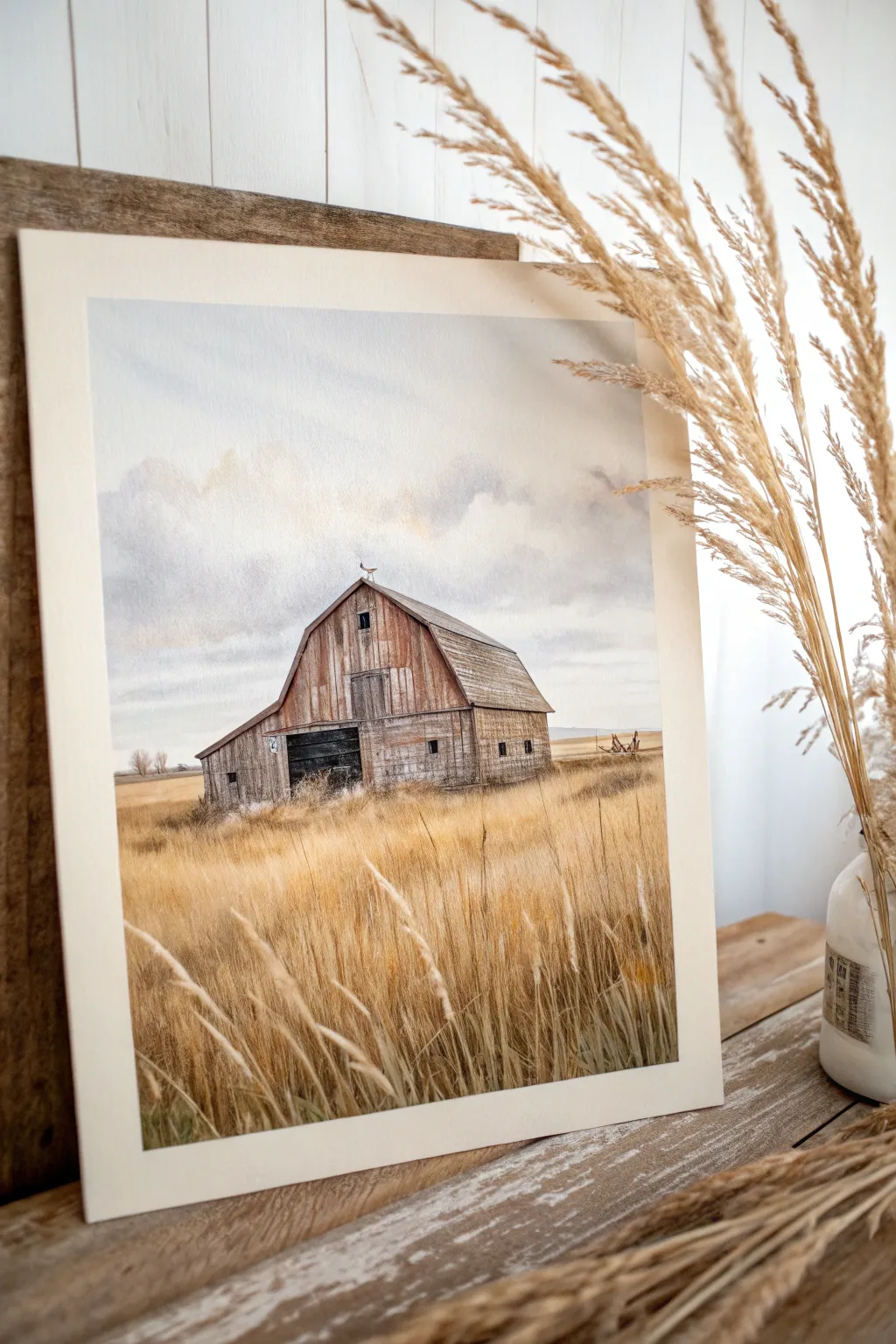 Paint a weathered barn landscape in warm neutrals with textured brushwork for rustic charm