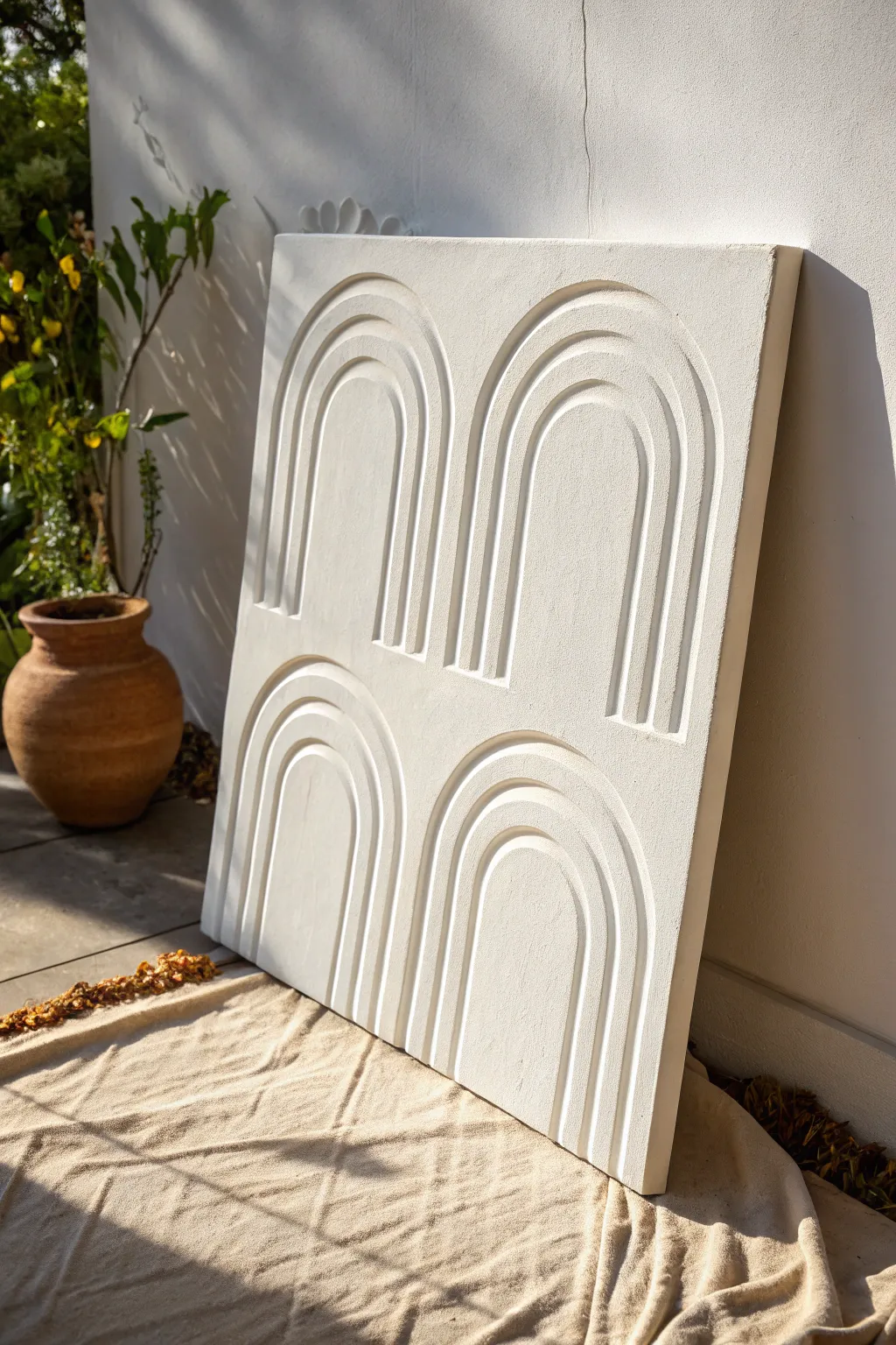 Minimalist raised arches in texture paste, sculpted shadows, calm monochrome contrast.