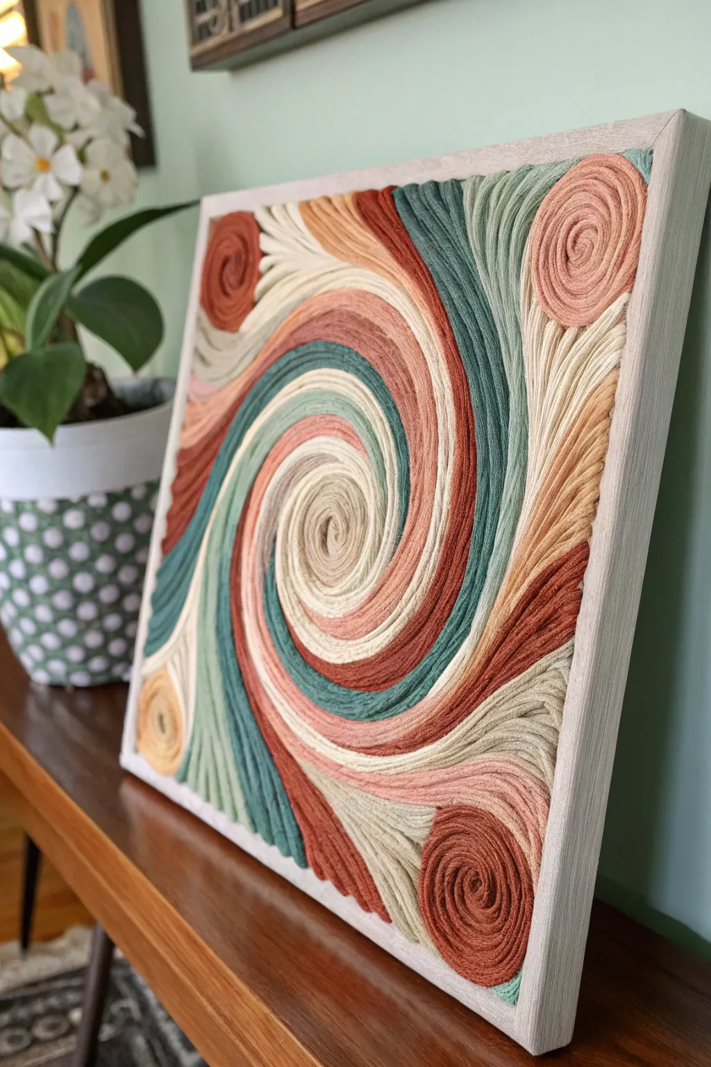 Classic abstract swirl yarn painting with rich texture, soft neutrals, and bold contrast