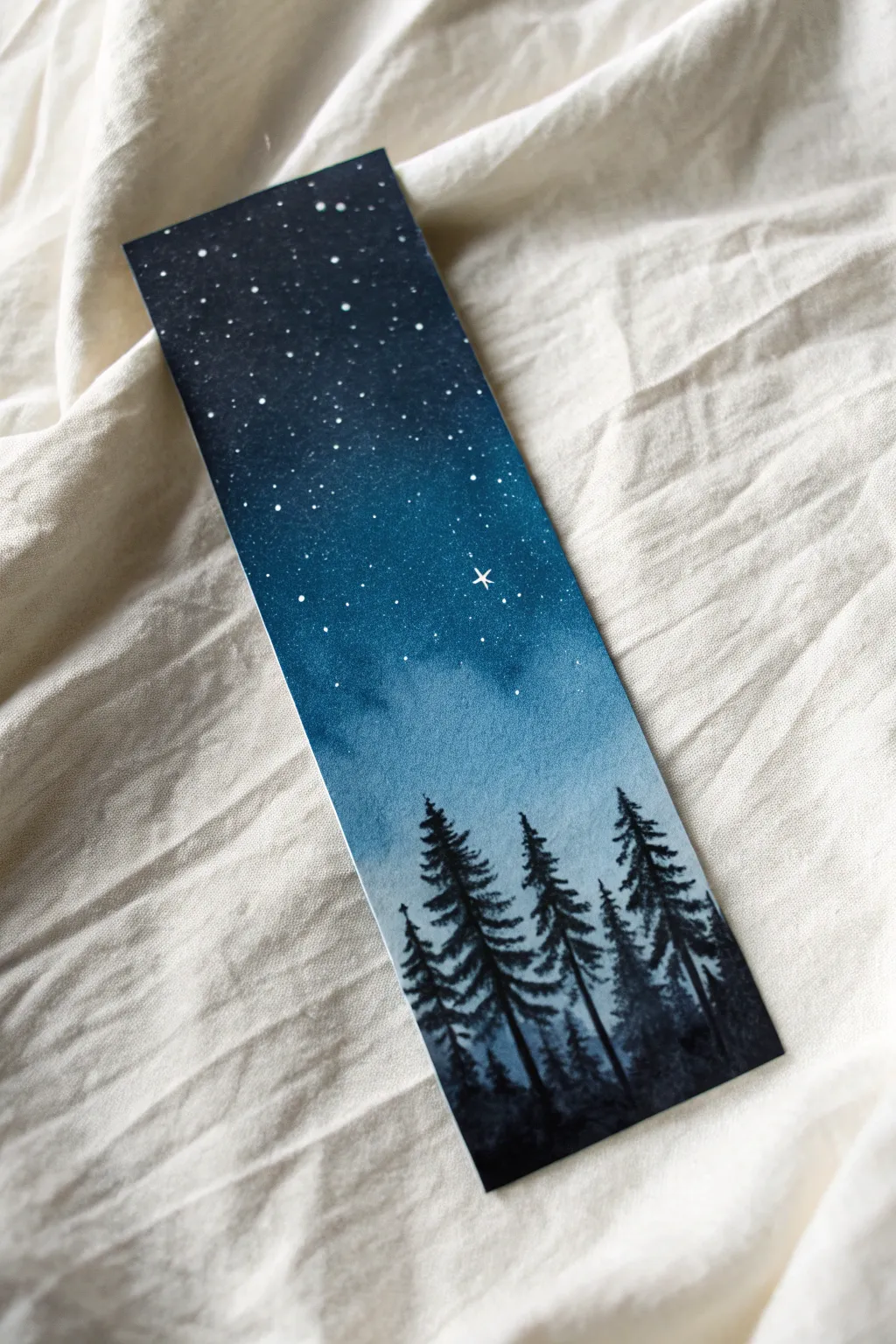 Deep indigo skies and pine silhouettes make for a dreamy reading companion.