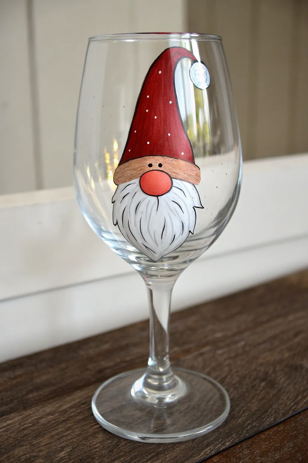 Paint a cozy Christmas gnome on a wine glass with a red hat bowl and flowing white beard