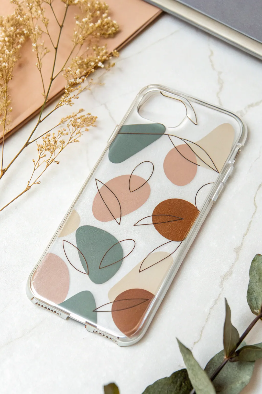 Clear phone case art: muted abstract blobs with thin outlines for a chic modern look