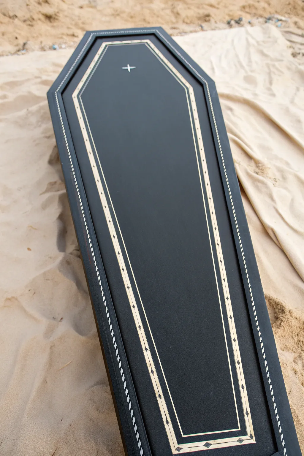 Dark coffin lid with an ivory bone border frame, leaving a clean center for a symbol or motif