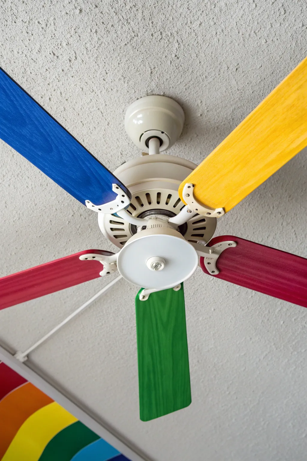 Rainbow painted fan blades create a bold ring spin effect, minimalist boho DIY ceiling update