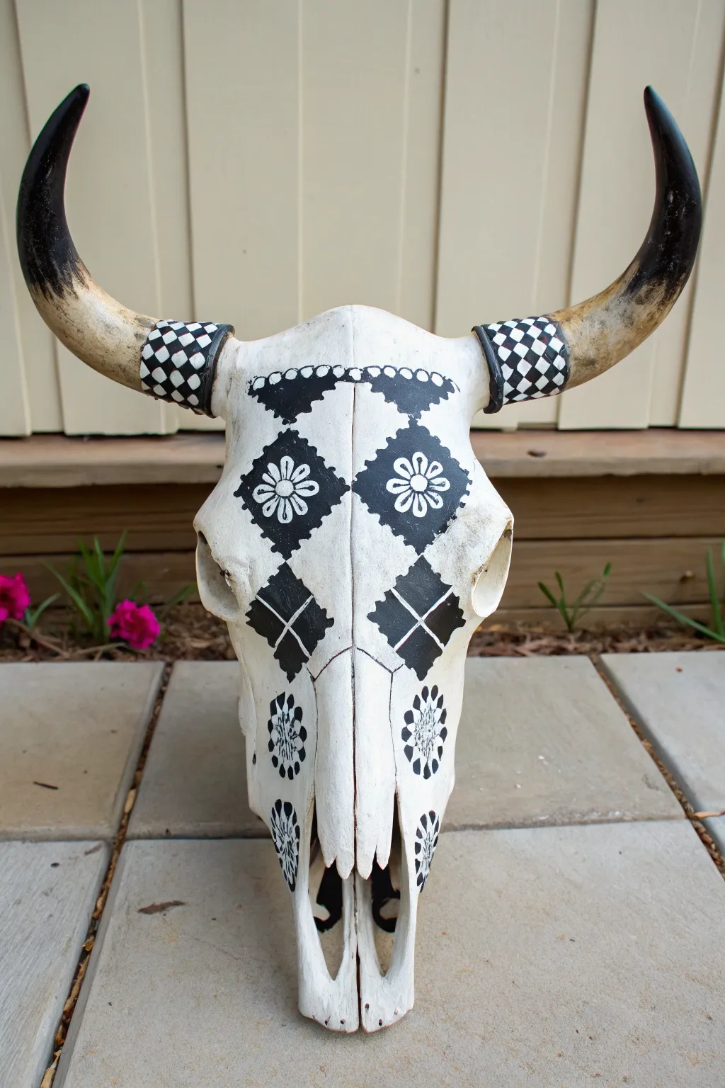 Bold black-and-white folk patterns on a DIY painted cow skull, minimalist boho contrast