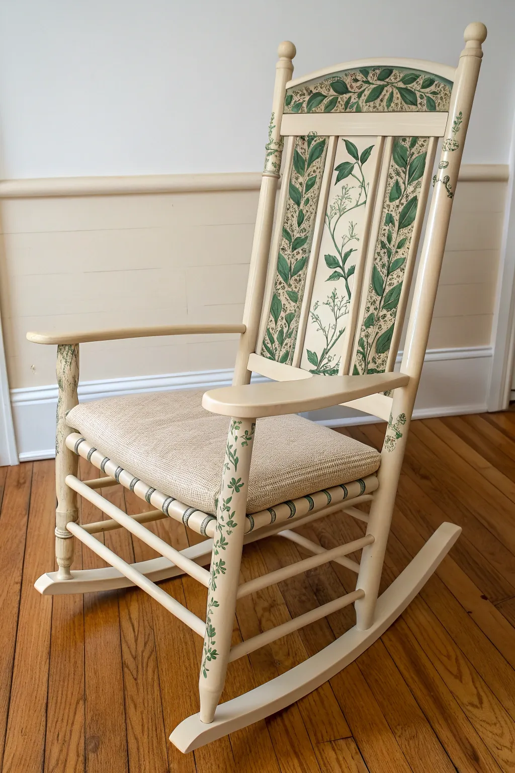 Soft ivory rocker with hand-painted green vines climbing the spindles, styled with leafy plants.