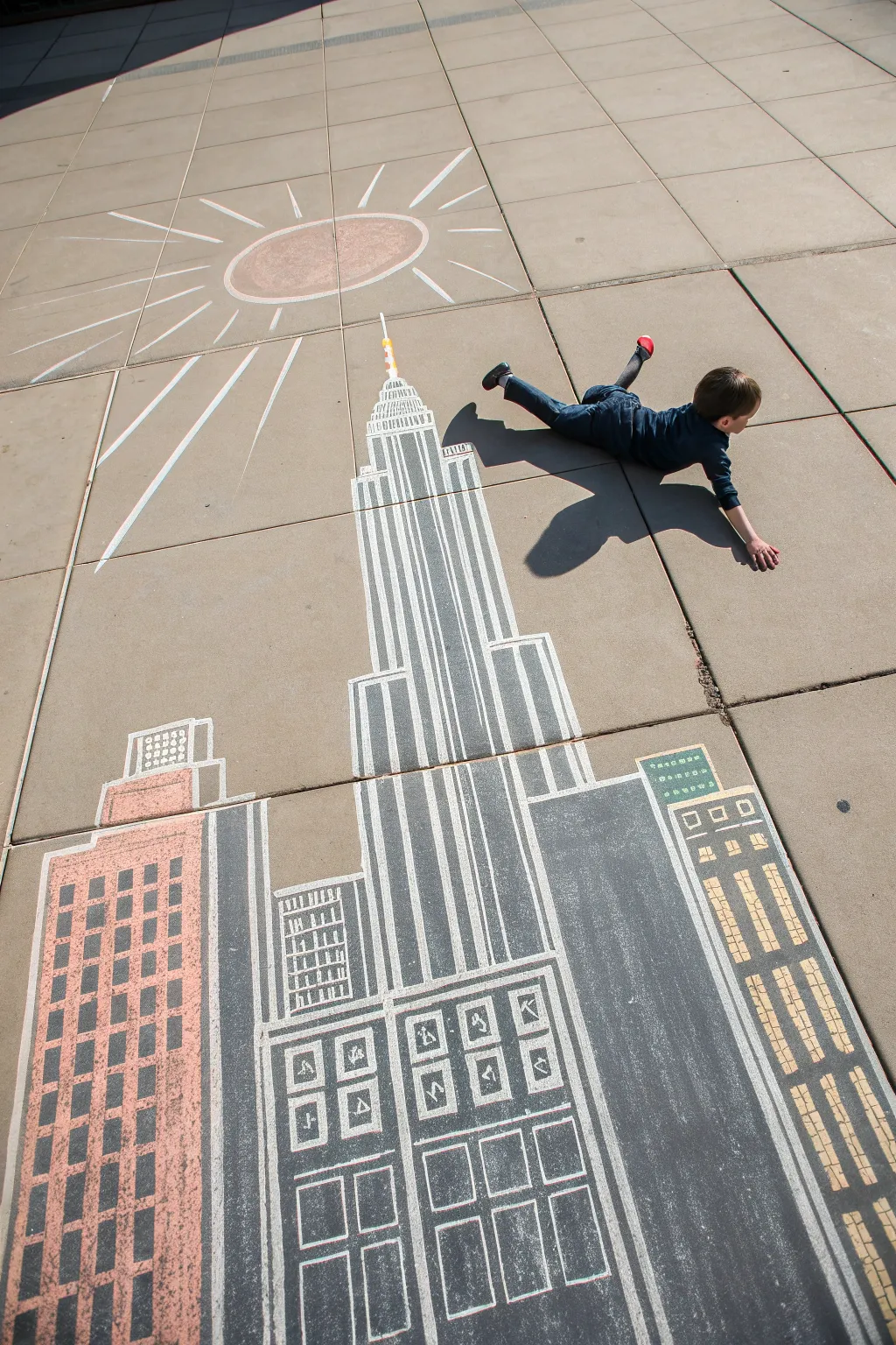 Minimal chalk skyline with a flying child shadow for an easy, high-contrast sidewalk illusion