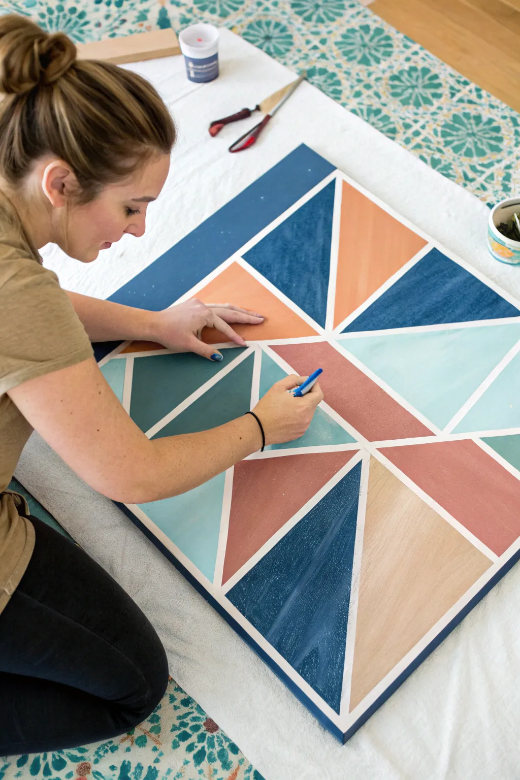 Peel-and-reveal tape-resist geometry for a satisfying group canvas project with bold contrast.