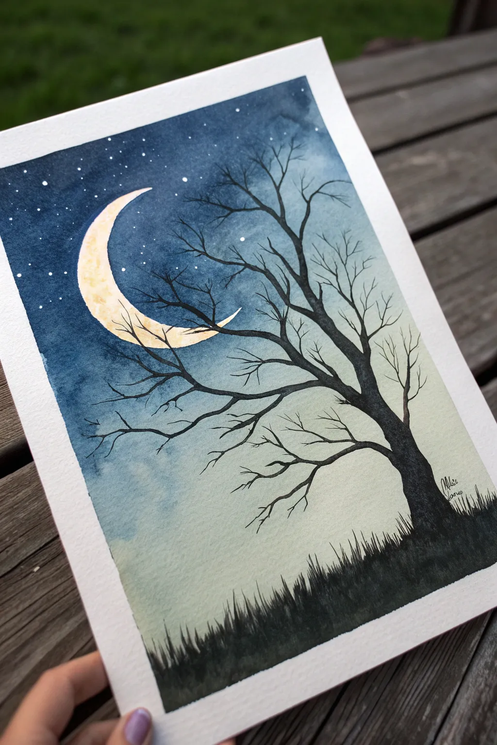 Paint a spooky yet minimal crescent moon with a bare tree silhouette for Halloween night vibes.