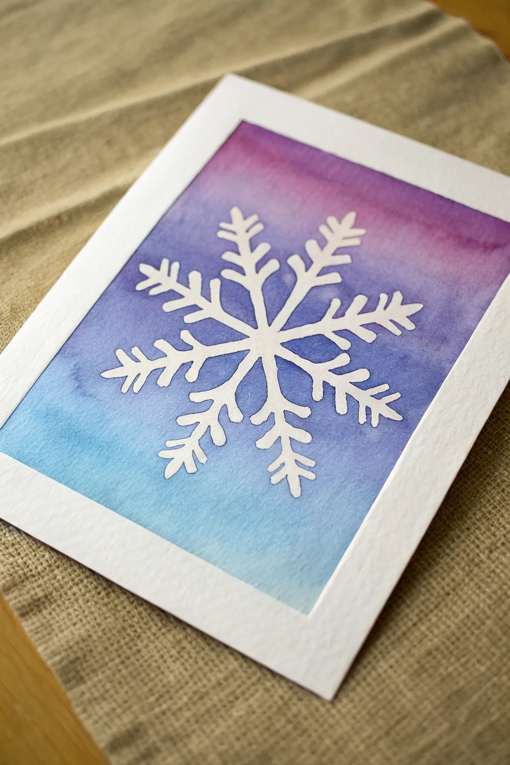 Ombre blue to violet wash with one crisp white snowflake for a clean winter painting idea