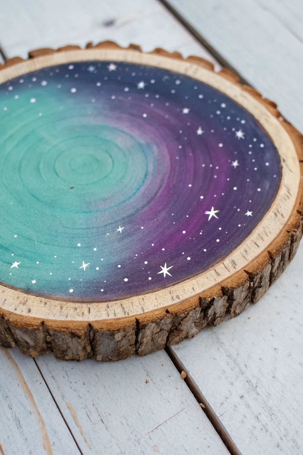 Minimal wood slice galaxy paint with tiny star dots and visible grain for a magical finish