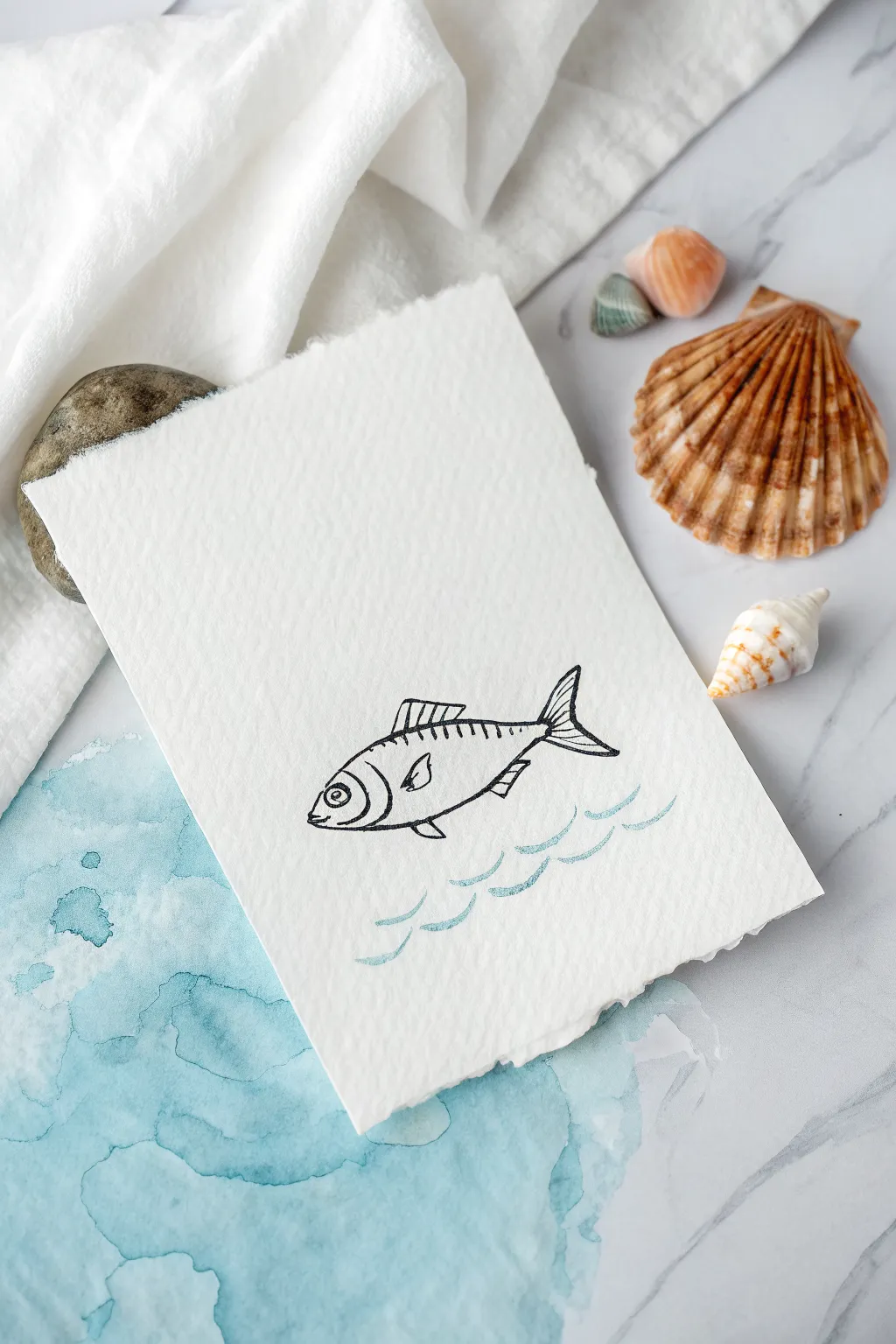 Minimal fish line art over a soft blue wash with a tiny fin accent, calm Scandinavian vibes
