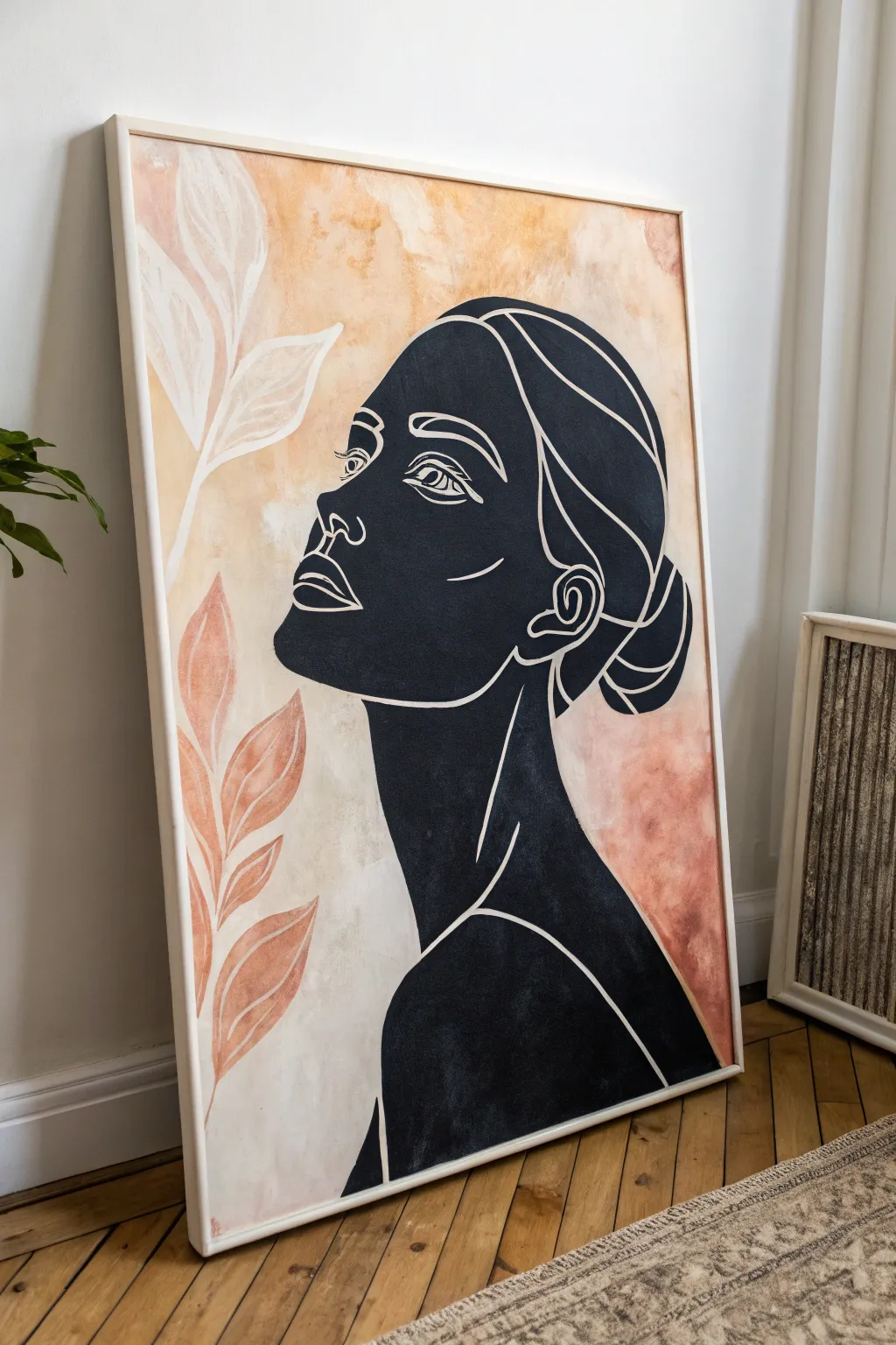Minimal line-art portrait with a soft blush wash, a modern focal canvas for a calm living room.