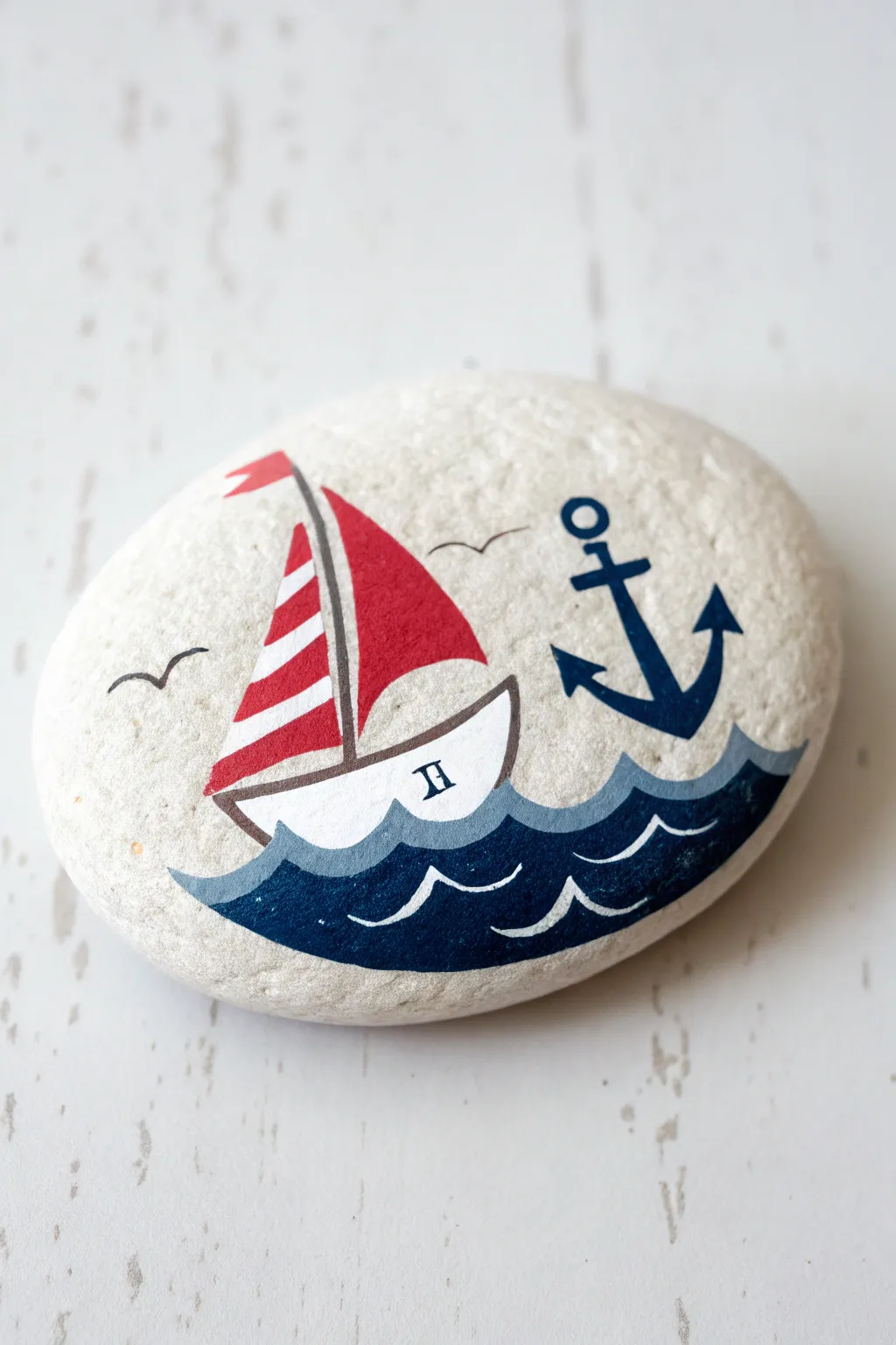 Preppy nautical rock: crisp sailboat on navy waves with a tiny anchor in red, white, and blue