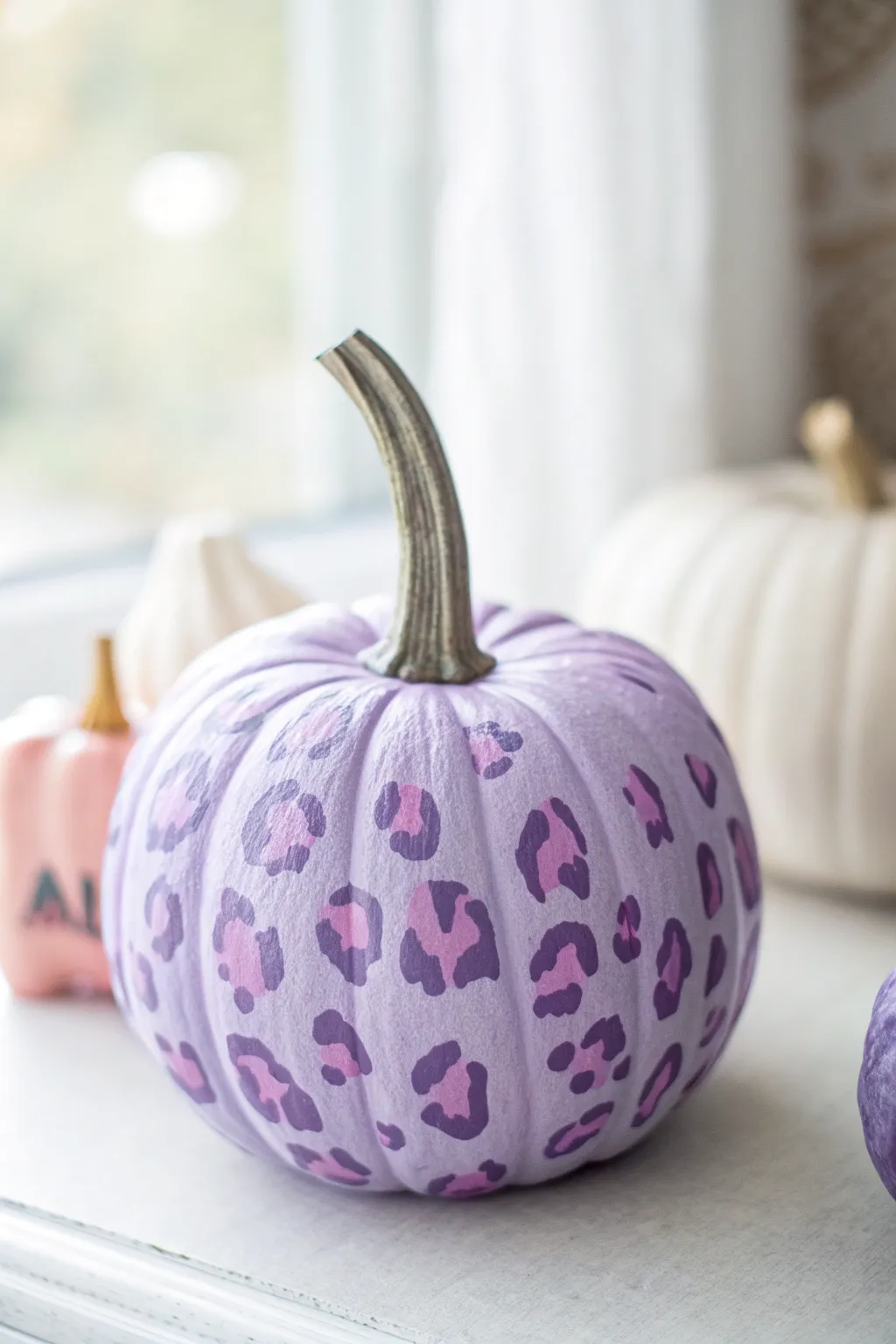 Deep purple pumpkin with pink leopard spots, a chic minimalist boho fall painting idea.