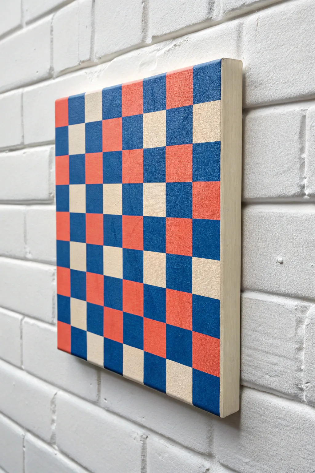 Tape-stenciled checkerboard pop art in bold coral and cobalt for an easy, graphic spray look