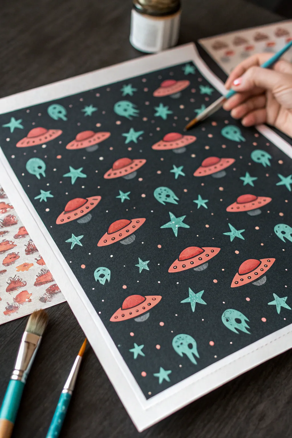 Mini UFO pattern painting: tiny ships, stars, and aliens in bold minimalist colors.