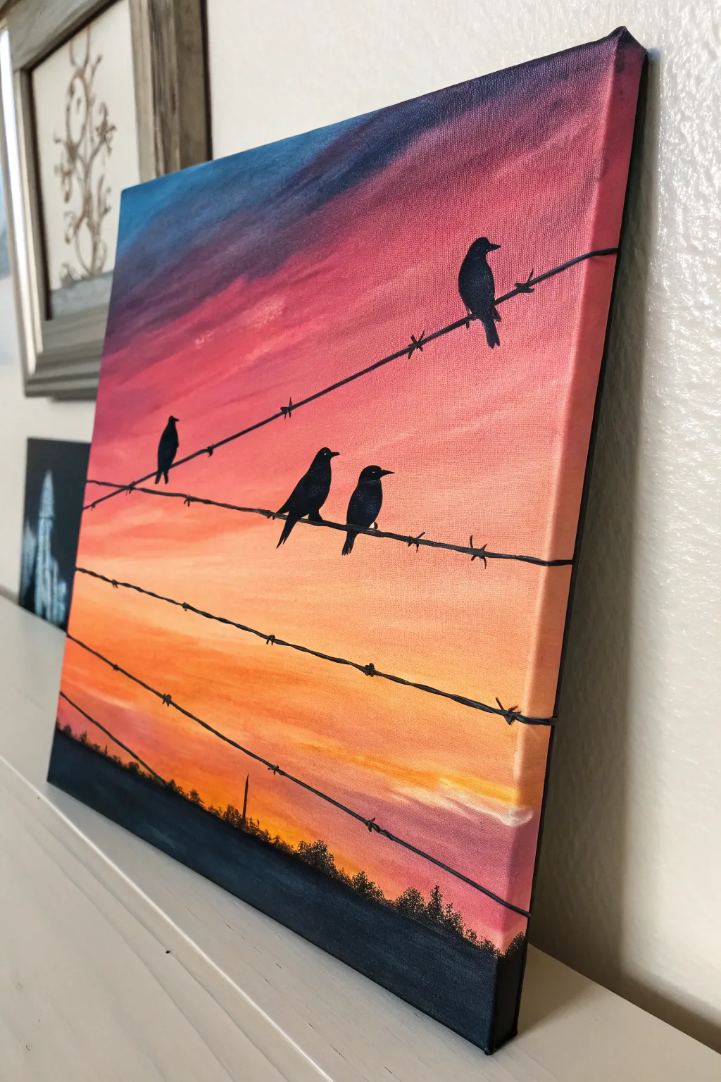 Paint chunky bird silhouettes on a wire against a bold sunset gradient—easy, modern, calming.