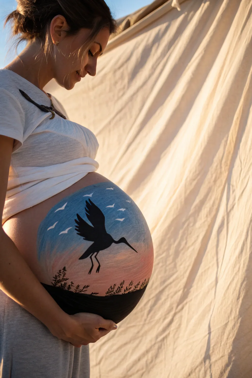Storybook stork silhouette belly painting with a bold sky gradient, minimal lines, and cozy boho calm.