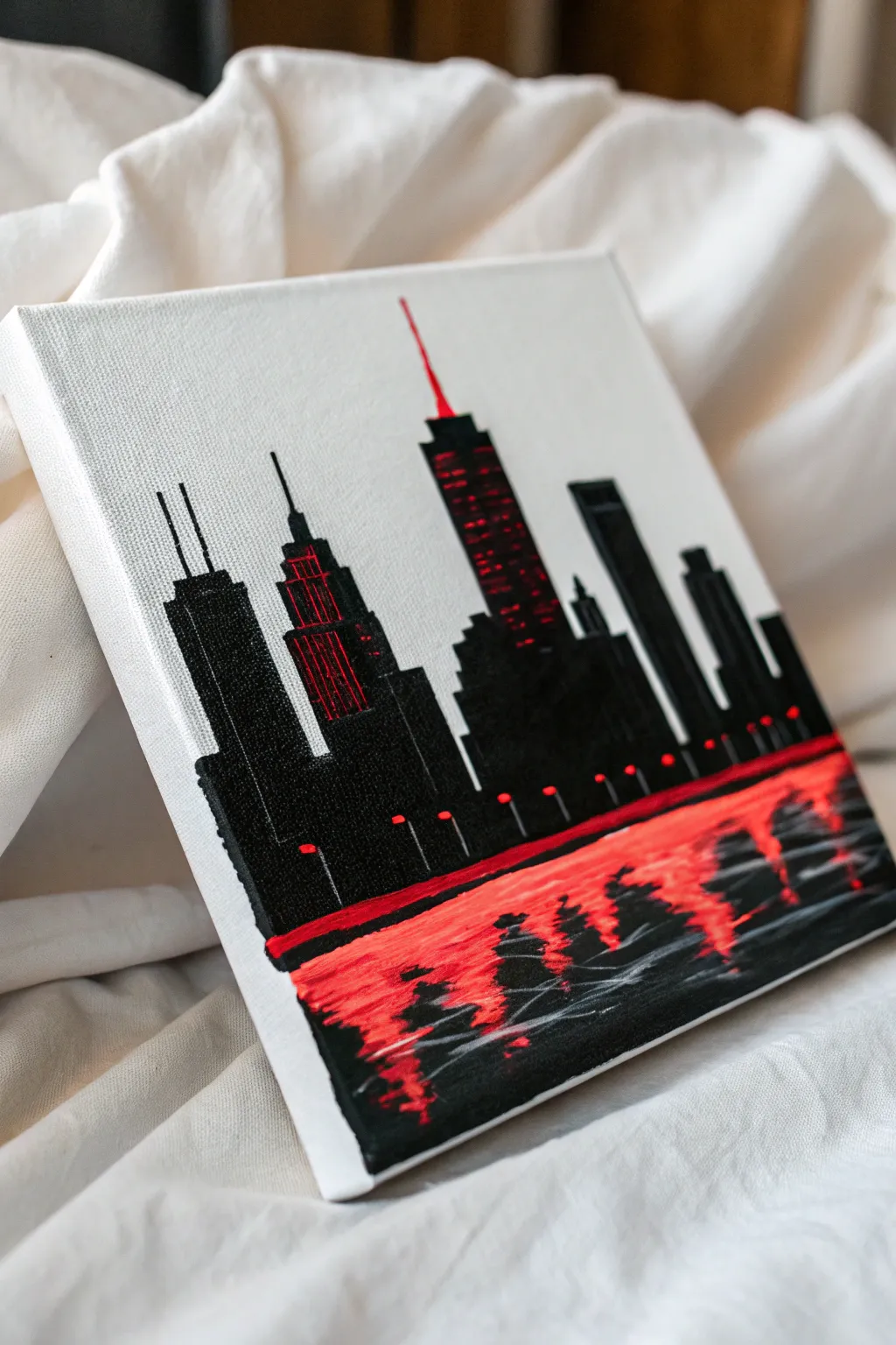 Minimal black skyline painting with bold red neon glow and dreamy reflections for modern drama