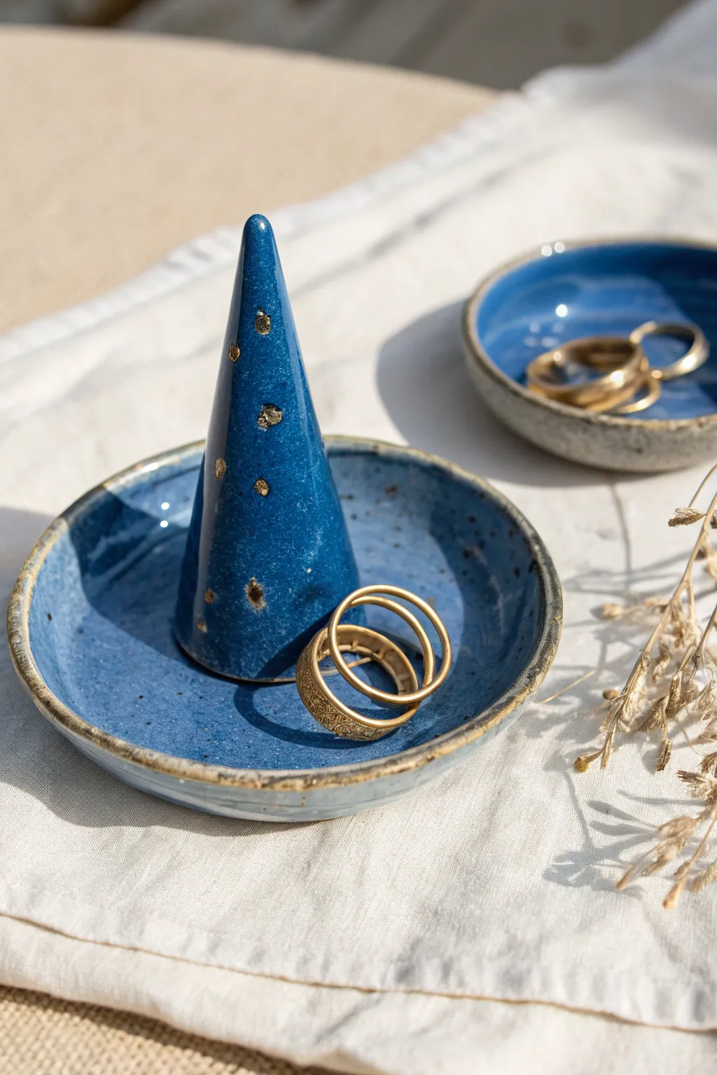 Bold cobalt ring cone and dish with stacked rings, minimalist boho craftsmanship in focus