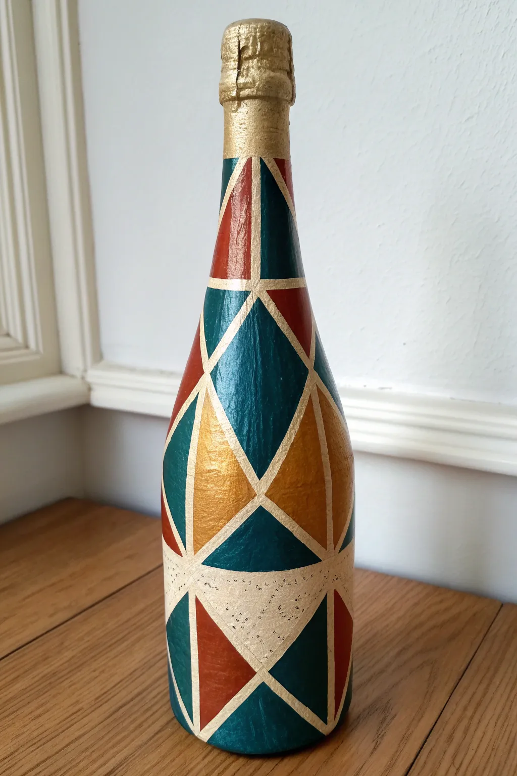 Geometric tape lines and bold color blocks turn a champagne bottle into modern art.