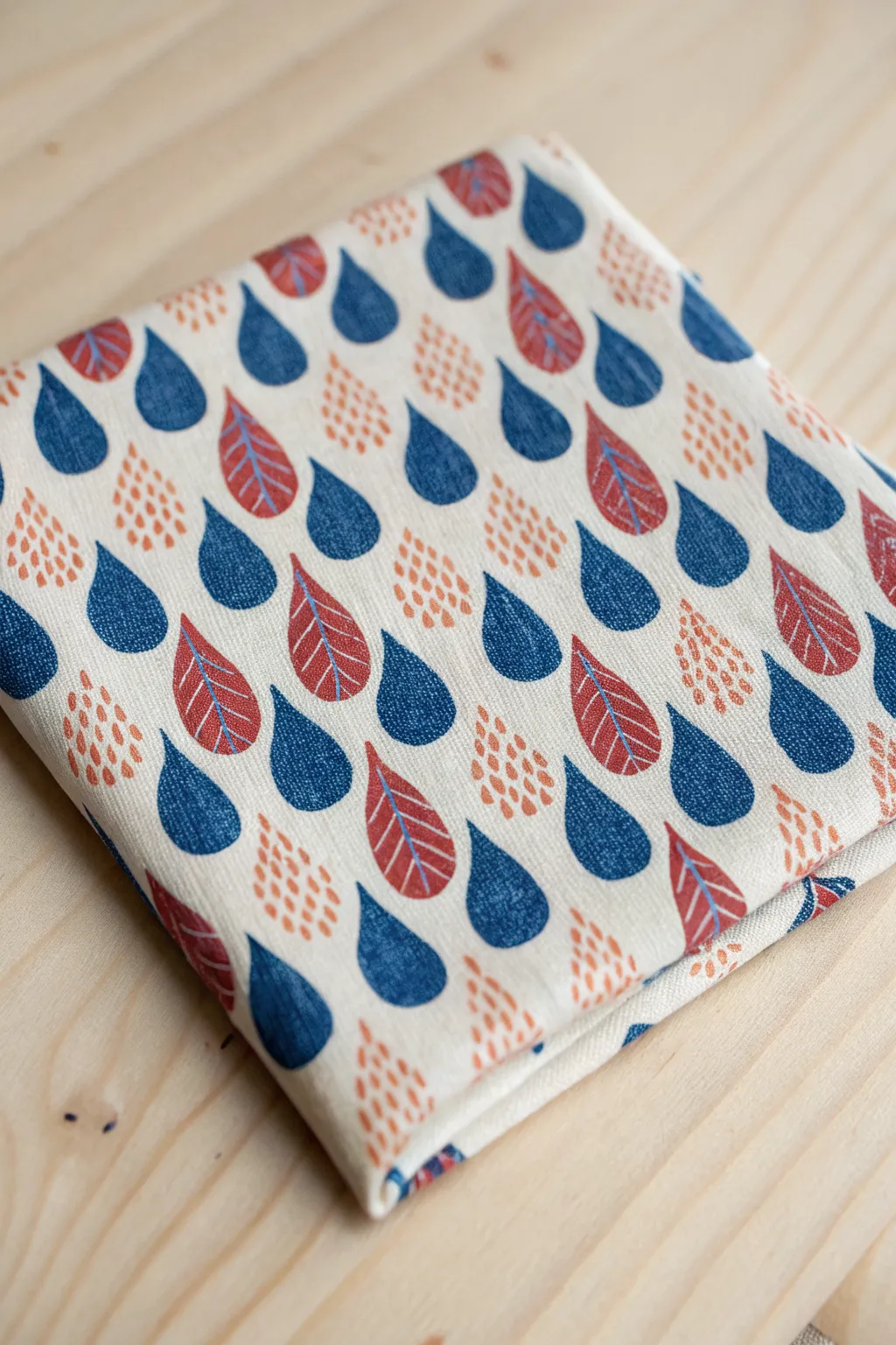 Tightly packed teardrop raindrops in cobalt and terracotta for a bold minimalist boho pattern