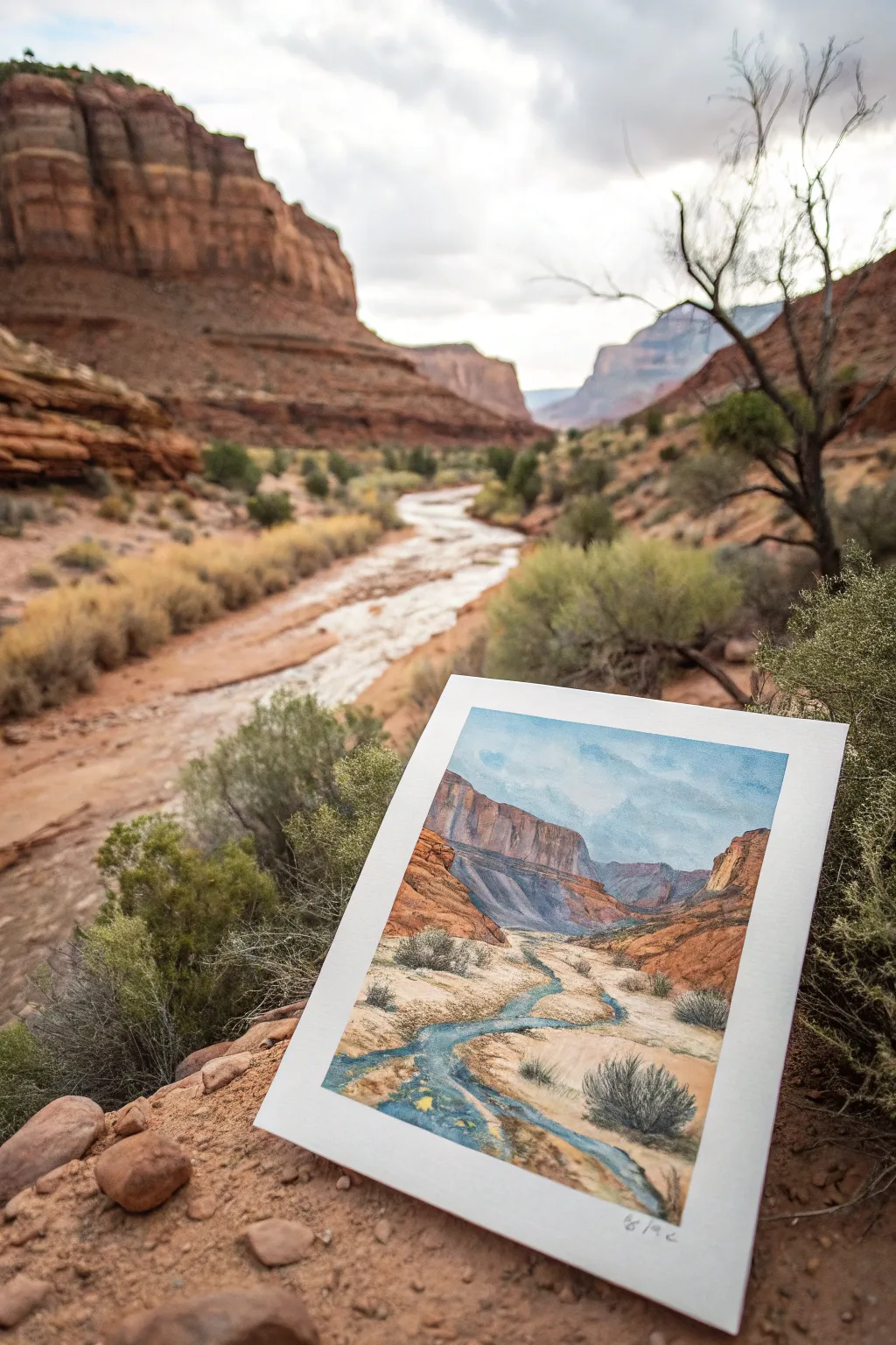 Desert wash painting: a winding dry riverbed with pebbles and dry-brush texture in bold contrast