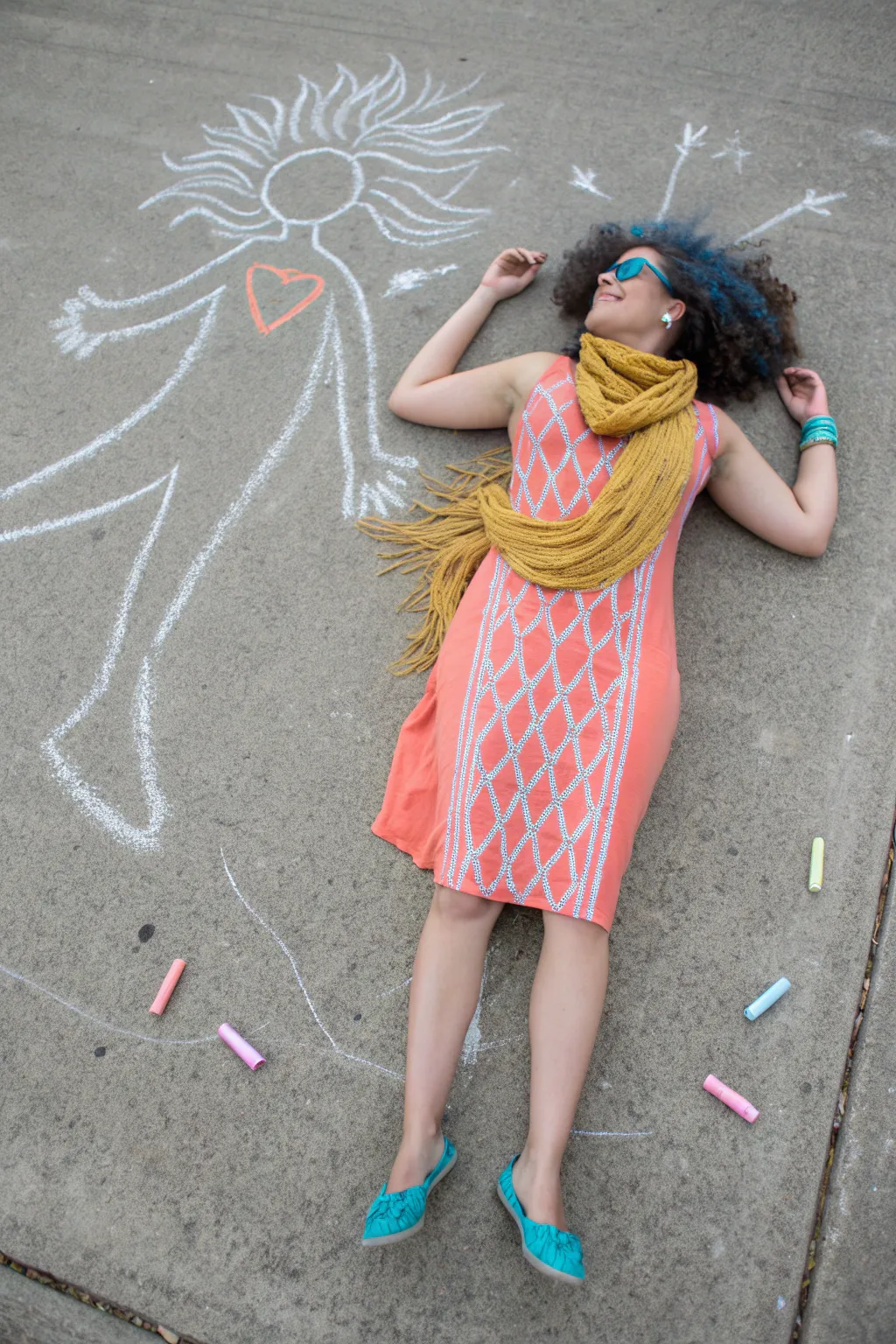 Life-size chalk silhouette portrait with bold boho costume details and bright color crayons nearby